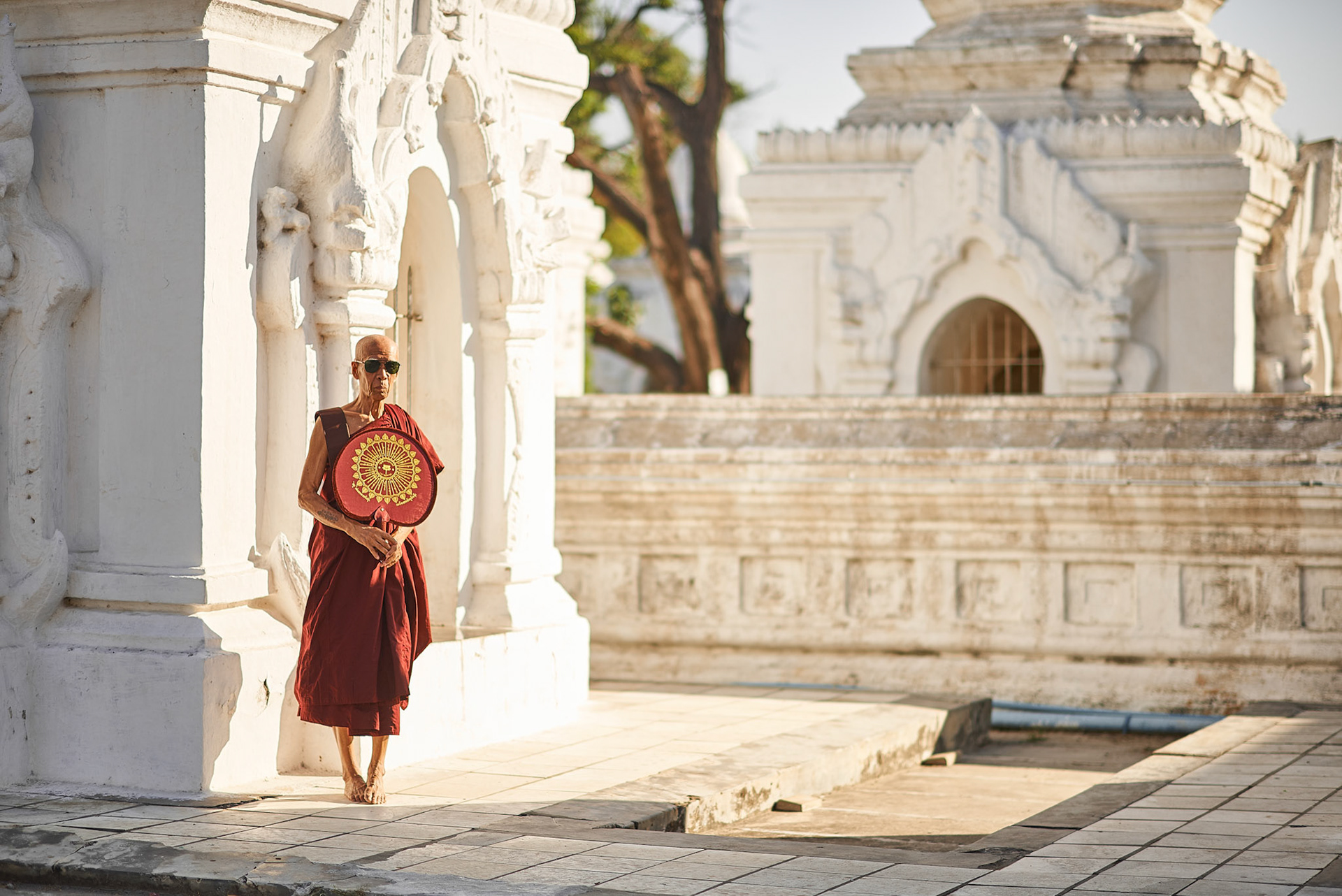 Monk with sunglasses and fan