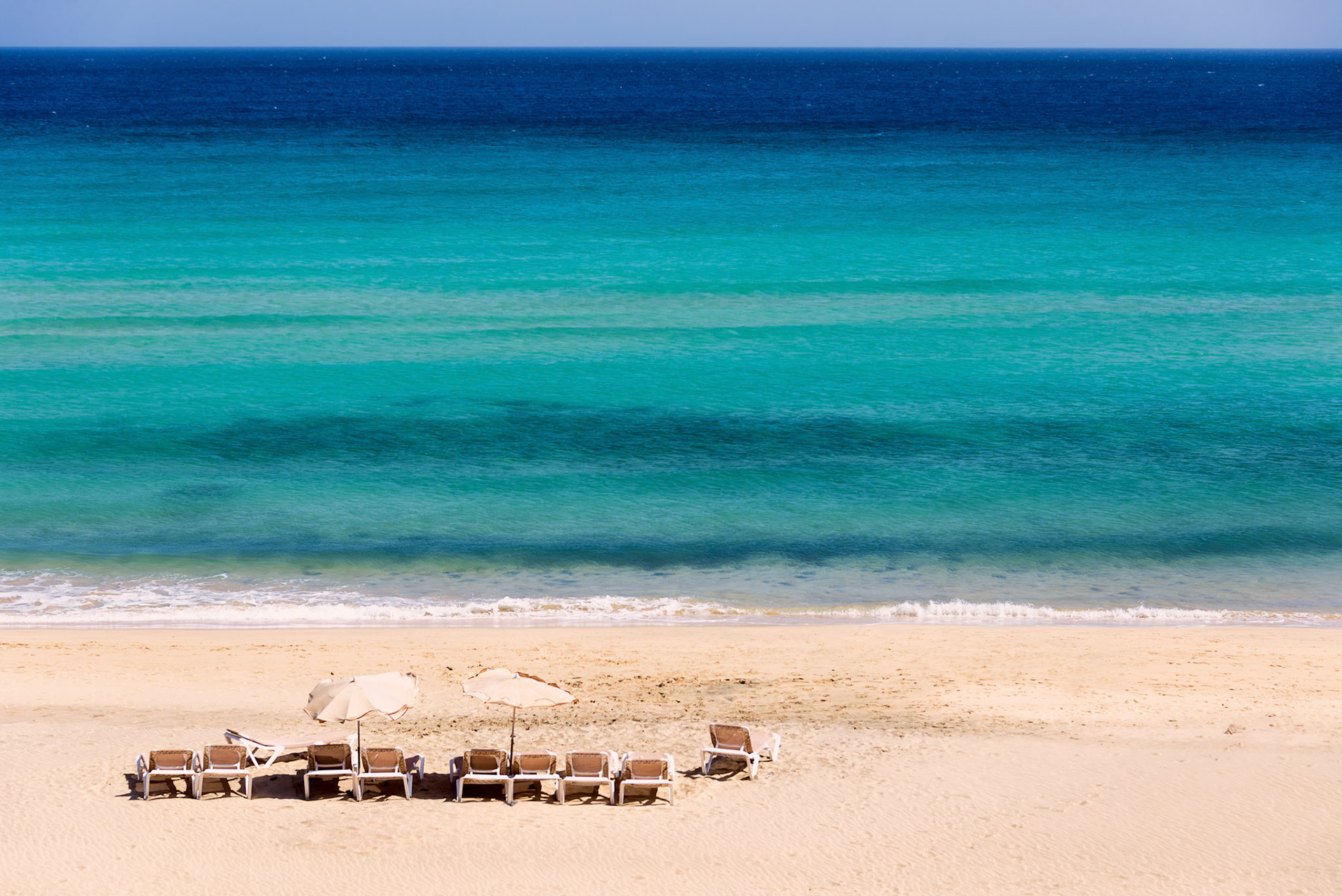 Sunbeds on an empty beach in Sicily