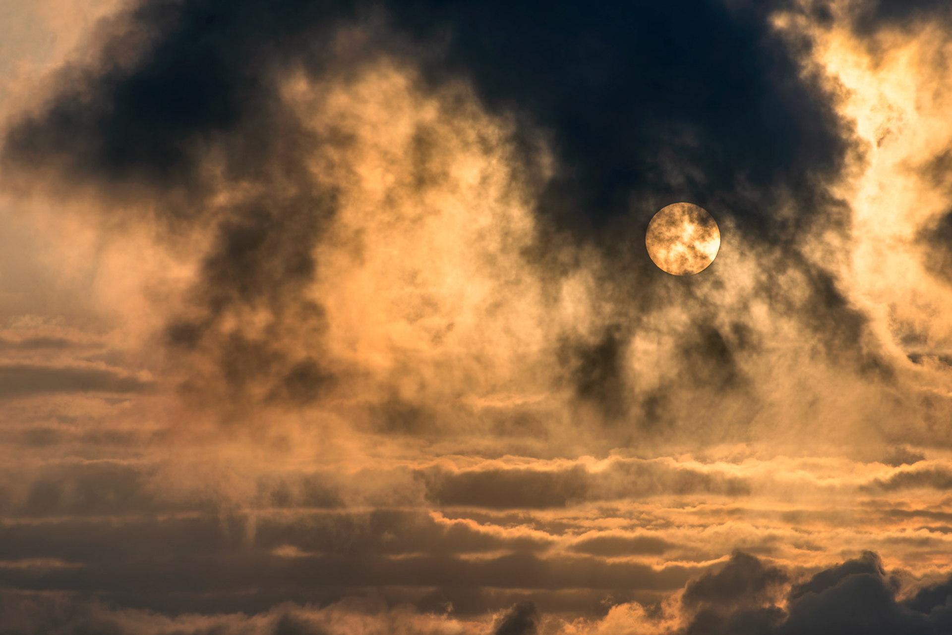 Dramatic golden sunrise above the clouds