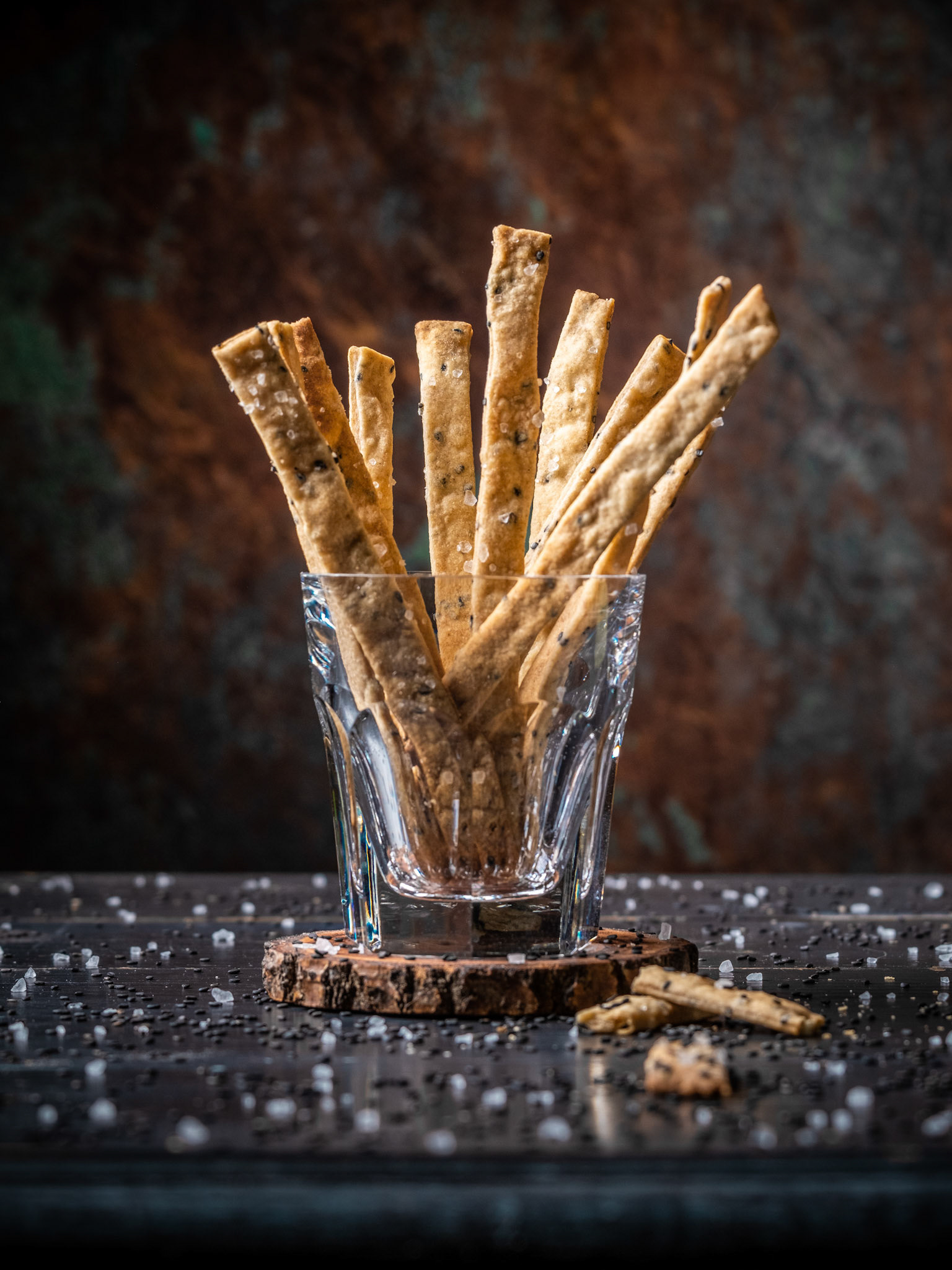 Black sesame rye sourdough crackers served in a glass