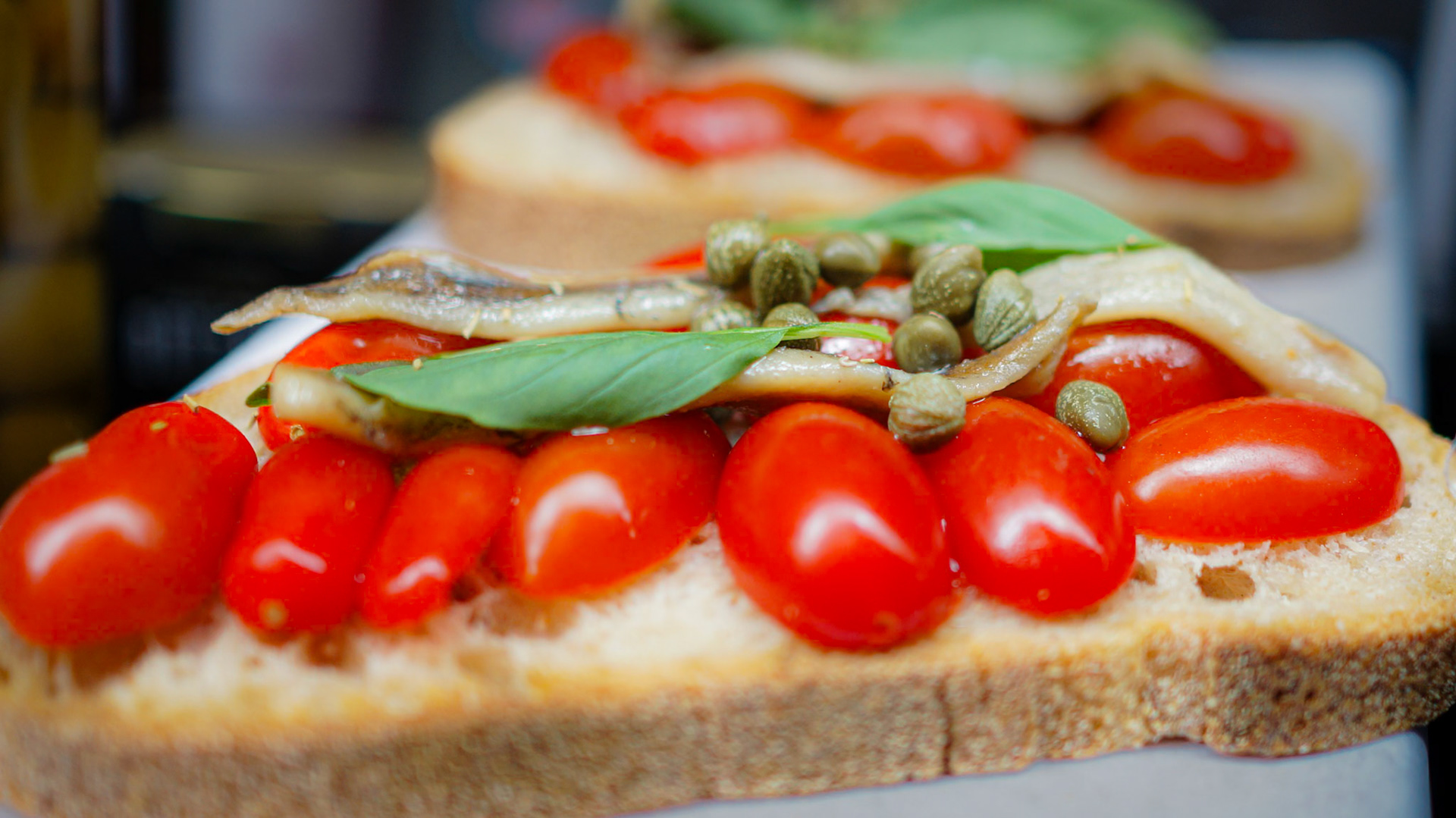 Tomatoes, caper, anchovies and basil