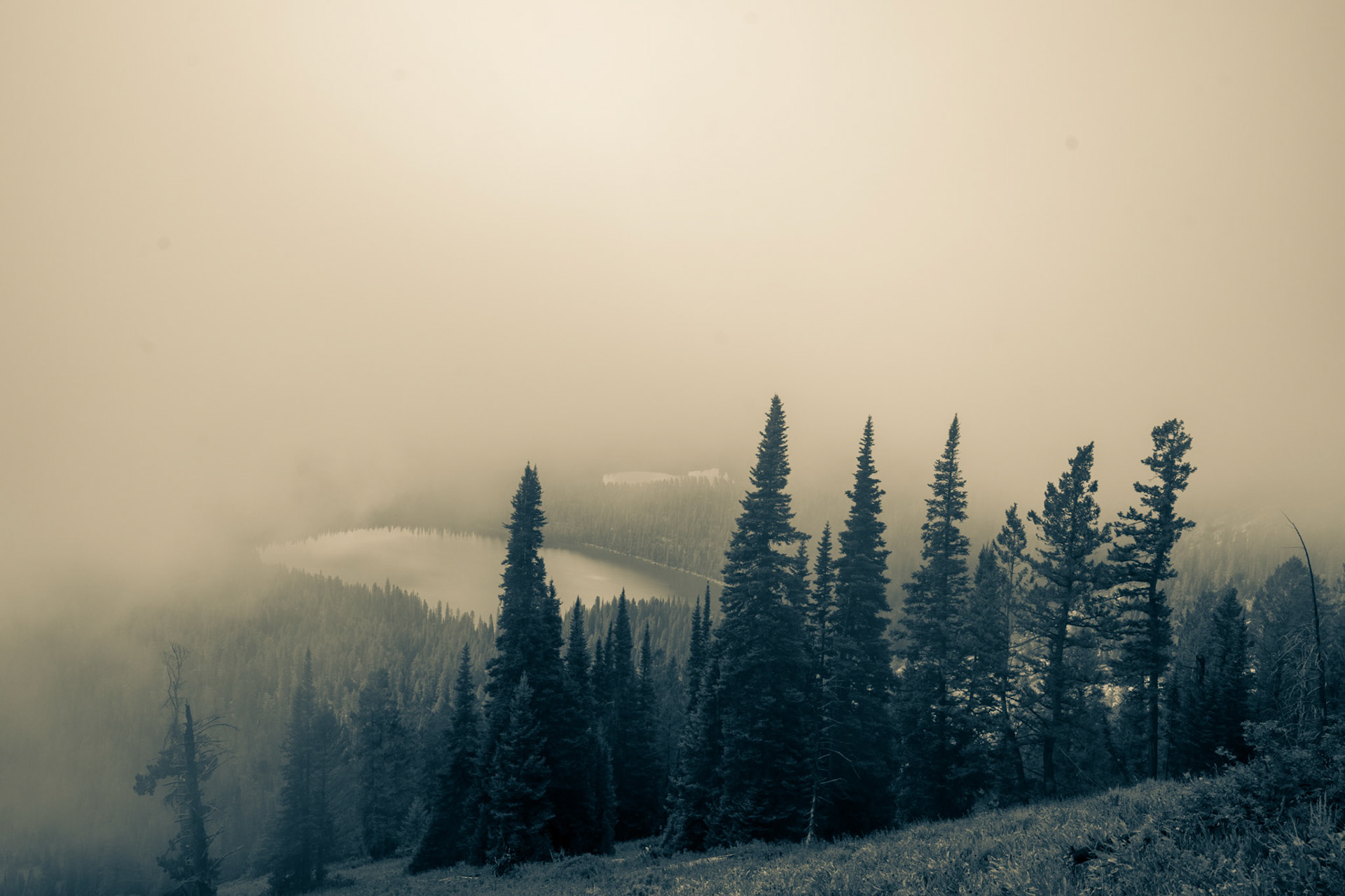 Looking down on Bradley and Taggart lakes, in Grand Teton National Park, from the Garnet Canyon trail through windows in the lifting morning fog.