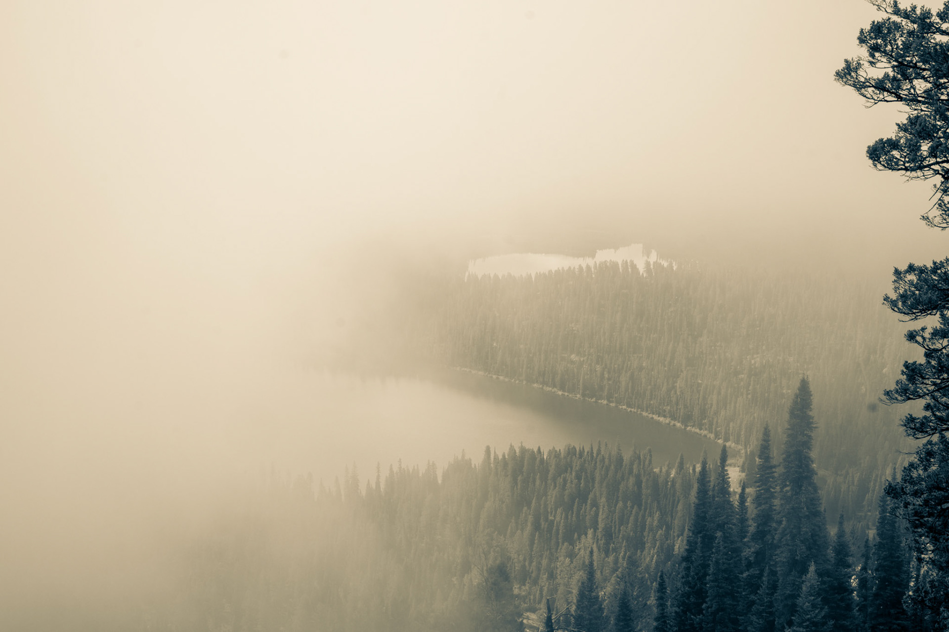 Looking down on Bradley and Taggart lakes, in Grand Teton National Park, from the Garnet Canyon trail through windows in the lifting morning fog.