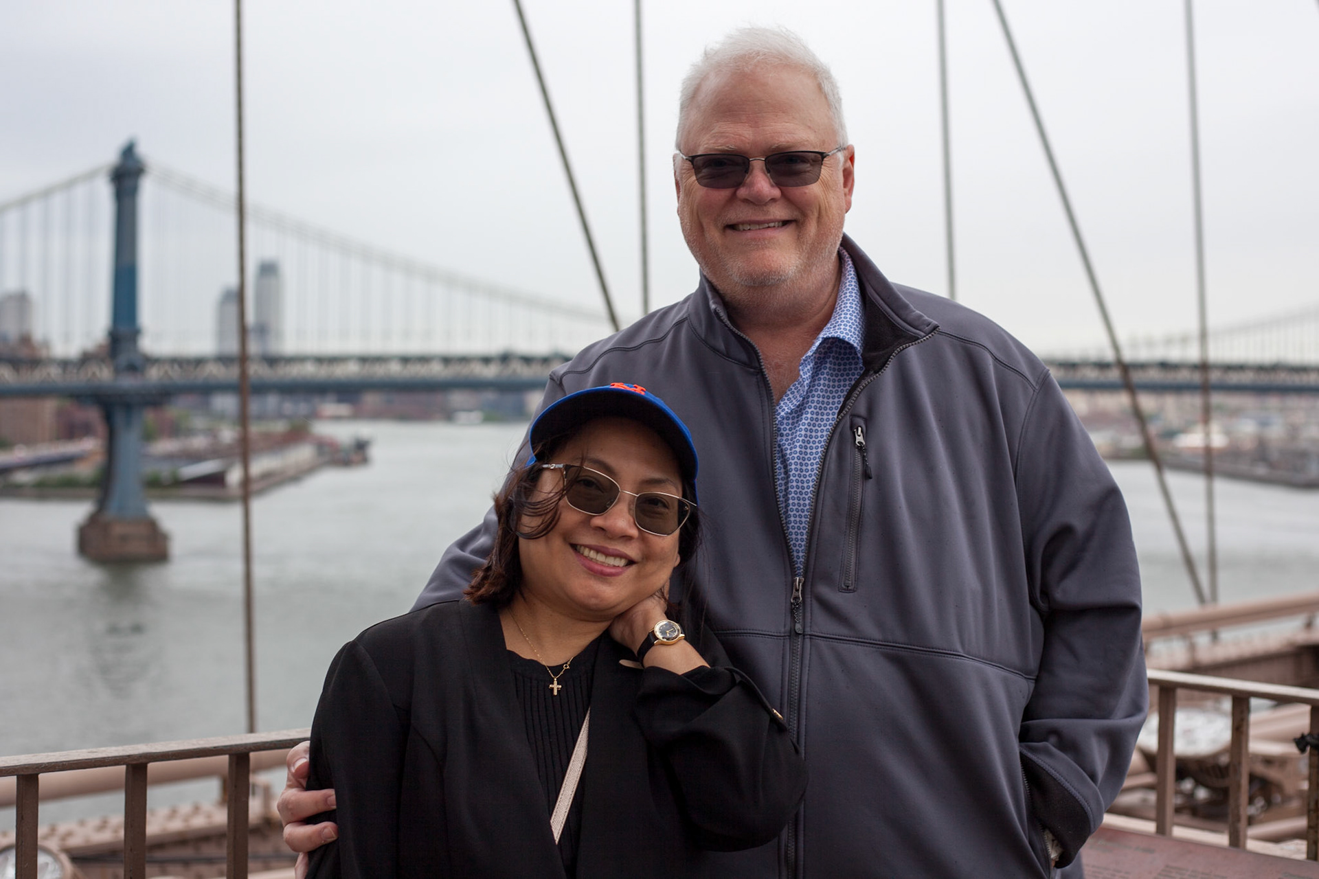 Cecile and Rick on Brooklyn Bridge with Manhattan Bridge in Background, NY.