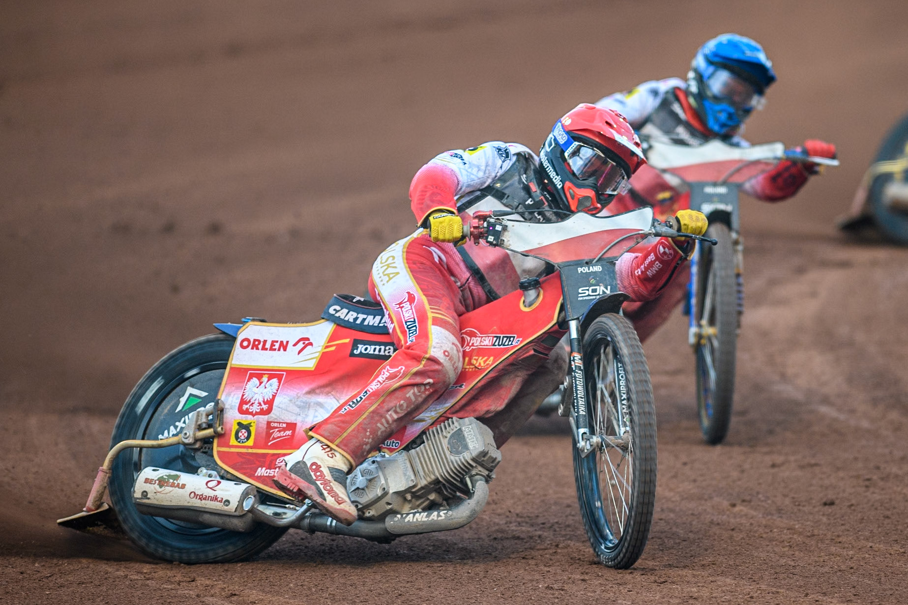 Dominik Kubera of Poland in Red leading team mate Bartosz Zmarzlik in Blue during the Monster Energy FIM Speedway of Nation Final at the National Speedway Stadium, Manchester on Saturday 13th July 2024. (Photo: Ian Charles | MI News)