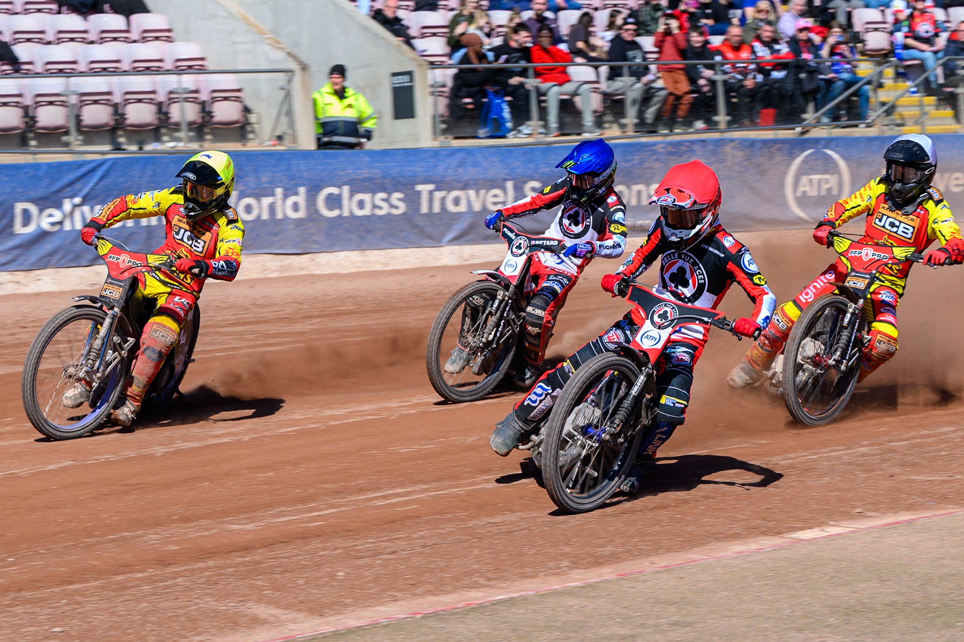 Zach Cook of Belle Vue Aces  in Red rides inside Ryan Douglas of Leicester Lions  in Yellow with Dan Bewley  of Belle Vue Aces  in Blue and Dan Thompson of Leicester Lions in White behind during the Knockout Cup Northern Section match between Belle Vue Aces and Leicester Lions at the National Speedway Stadium, Manchester on Monday 6th April 2026. (Photo: Ian Charles | MI News)