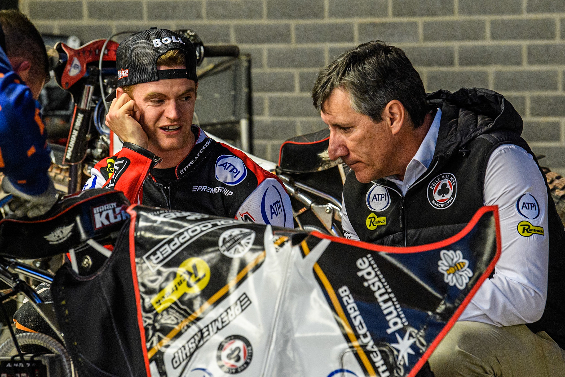 Belle Vue Aces' Brady Kurtz (Left) chats with Belle Vue Aces' Team Manager Mark Lemon during the Rowe Motor Oil Premiership match between Belle Vue Aces and Leicester Lions at the National Speedway Stadium, Manchester on Monday 19th May 2025. (Photo: Ian Charles | MI News)