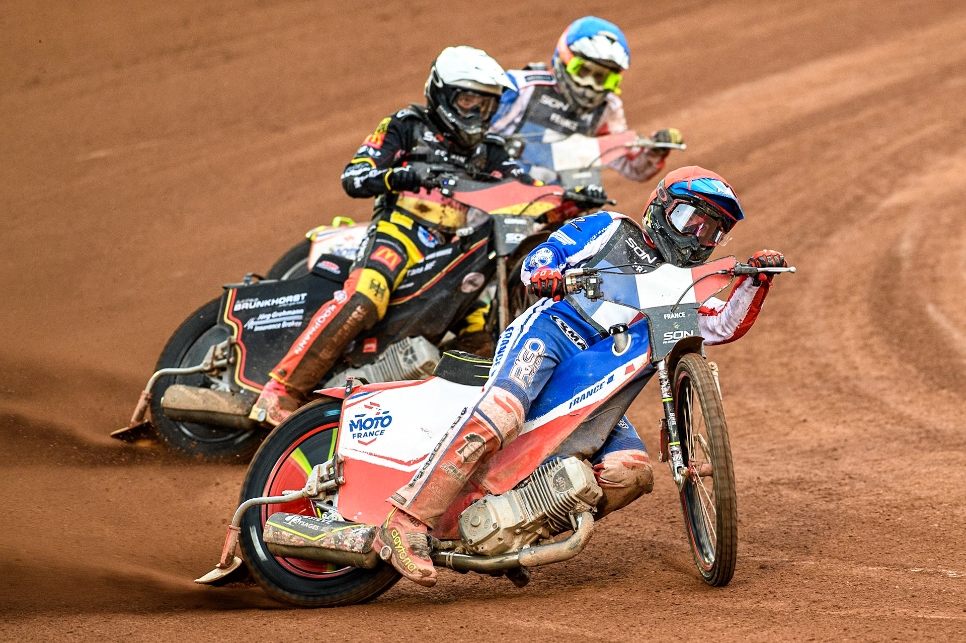 France v Germany: Jesse Mustonen of Finland in Red leading Kai Huckenbeck of Germany in White and Steven Goret of France in Blue during the Monster Energy FIM Speedway of Nations Semi-Final 1 at the National Speedway Stadium, Manchester on Tuesday 9th July 2024. (Photo: Ian Charles | MI News)
