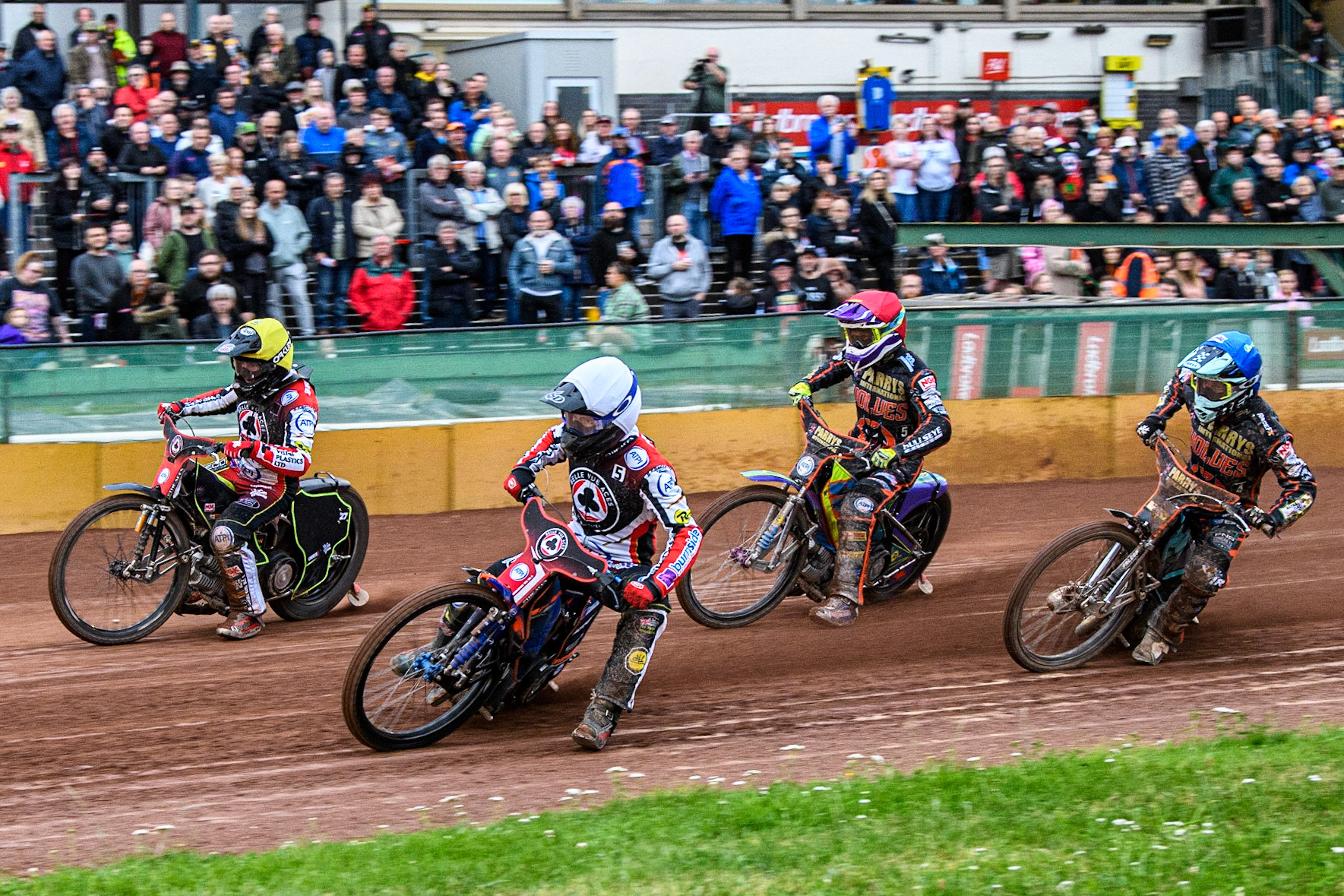 Brady Kurtz (White) and Tom Brennan (Yellow) go for maximum points ahead of Rory Schlein (Red) and Ryan Douglas (Blue) during the Sports Insure Premiership match between Wolverhampton Wolves and Belle Vue Aces at Monmore Green Stadium, Wolverhampton on Monday 10th July 2023. (Photo: Ian Charles | MI News)