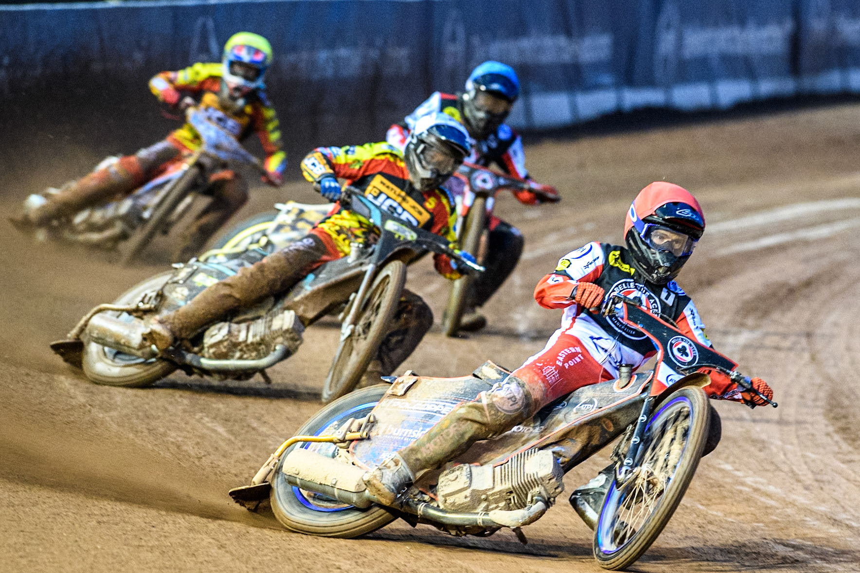 Brady Kurtz of Belle Vue Aces in Red leading Ryan Douglas of Leicester Lions in White Norick Blödorn of Belle Vue Aces in Blue and Drew Kemp of Leicester Lions in Yellow during the Rowe Motor Oil Premiership match between Belle Vue Aces and Leicester Lions at the National Speedway Stadium, Manchester on Saturday 6th April 2024. (Photo: Ian Charles | MI News)