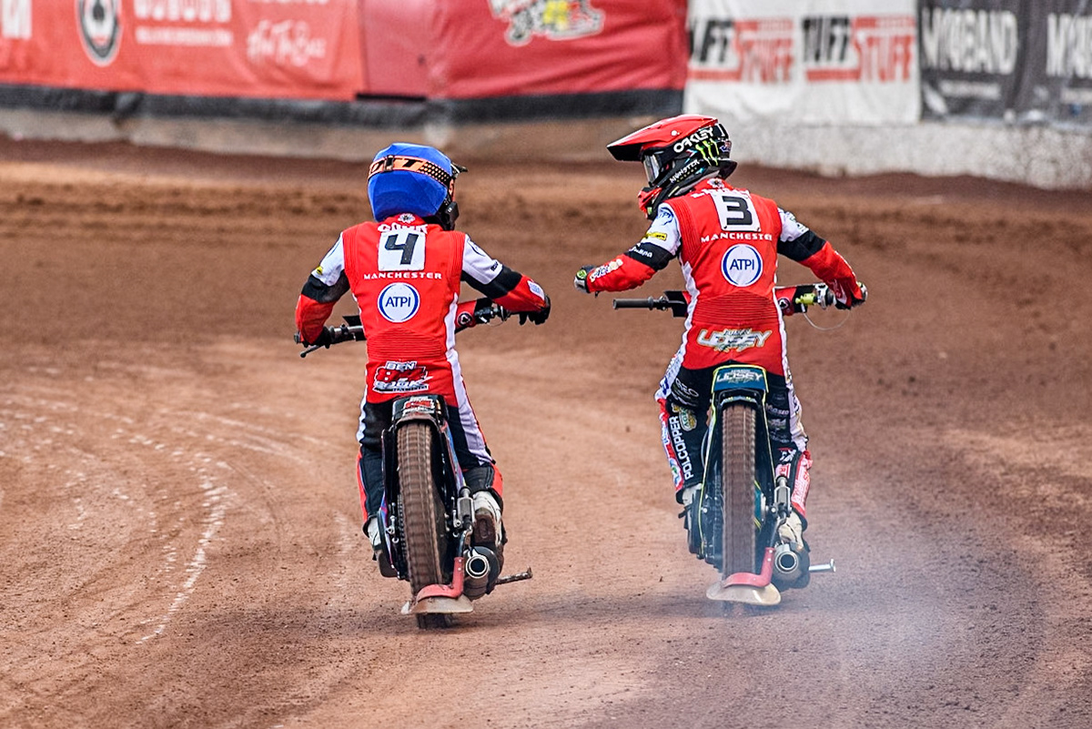 Belle Vue Aces' Jaimon Lidsey in Red celebrates their heat win with team mate Belle Vue Aces' Ben Cook in Blue during the Rowe Motor Oil Premiership match between Belle Vue Aces and Leicester Lions at the National Speedway Stadium, Manchester on Monday 24th June 2024. (Photo: Ian Charles | MI News)