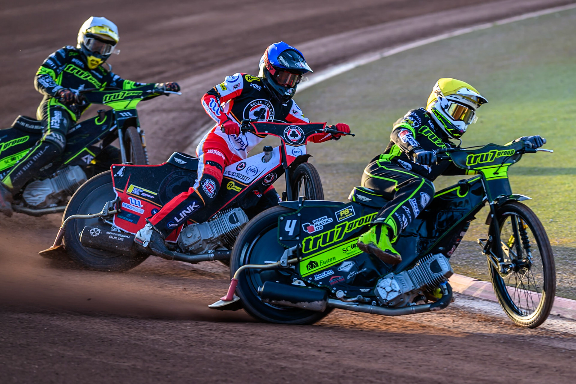 Tom Brennan of Ipswich Witches  in Yellow, leading Zach Cook of Belle Vue Aces  in Blue and Adam Ellis of Ipswich Witches  in White during the Rowe Motor Oil Premiership match between Belle Vue Aces and Ipswich Witches at the National Speedway Stadium, Manchester on Monday 4th August 2025. (Photo: Ian Charles | MI News)