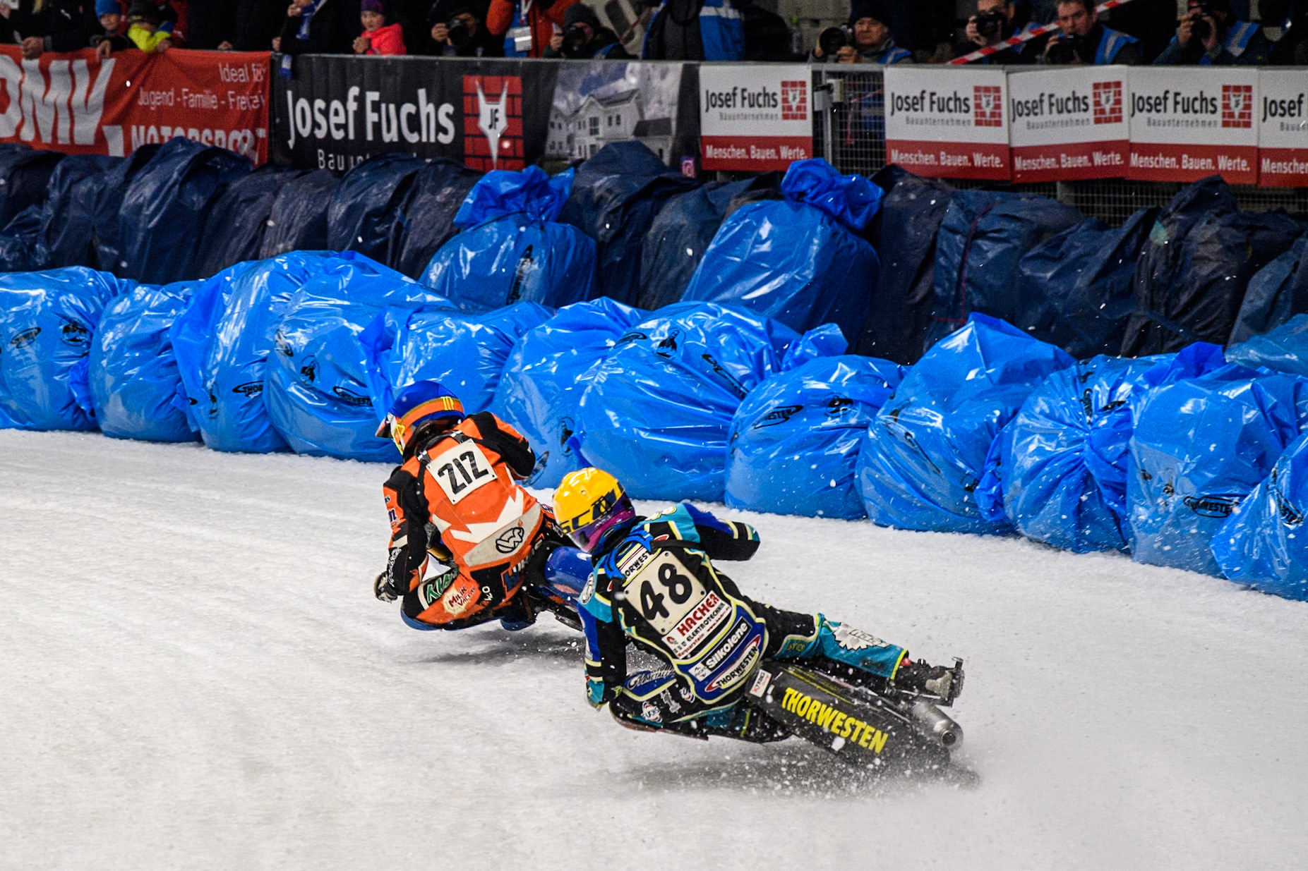 Luca Bauer (48) of Germany in Yellow chases Lukas Hutla (212) of the Czech Republic in Blue during the Ice Speedway Gladiators World Championship Final 1 at Max-Aicher-Arena, Inzell on Saturday 15th March 2025. (Photo: Ian Charles | MI News)