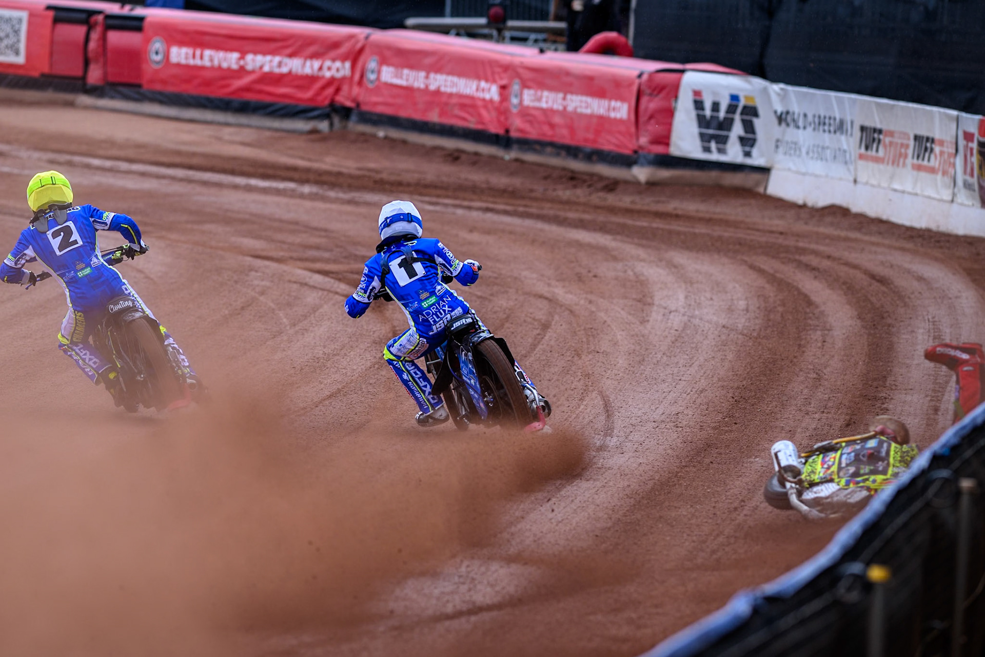 Belle Vue Colts' William Cairns falls whilst trying to pass Oxford Chargers' Jody Scott  in White and Oxford Chargers' Jacob Clouting  in Yellow during the WSRA National Development League match between Belle Vue Colts and Oxford Chargers at the National Speedway Stadium, Manchester on Sunday 1st June 2025. (Photo: Ian Charles | MI News)