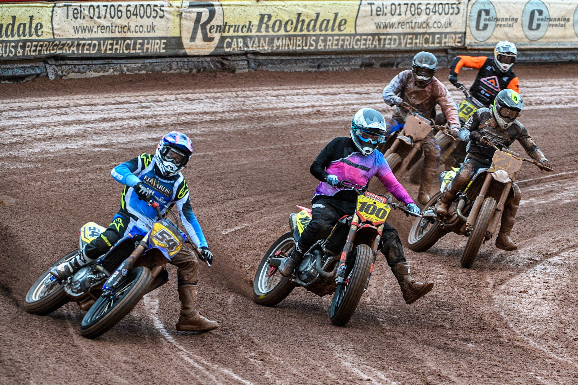 Tim Neave (54) from Great Britain outside Menno Van Meer (100) from Netherlands as they lead the pack during the FIM World Flat Track Championship Round 1 at the National Speedway Stadium, Manchester on Saturday 5th August 2023. (Photo: Ian Charles | MI News)