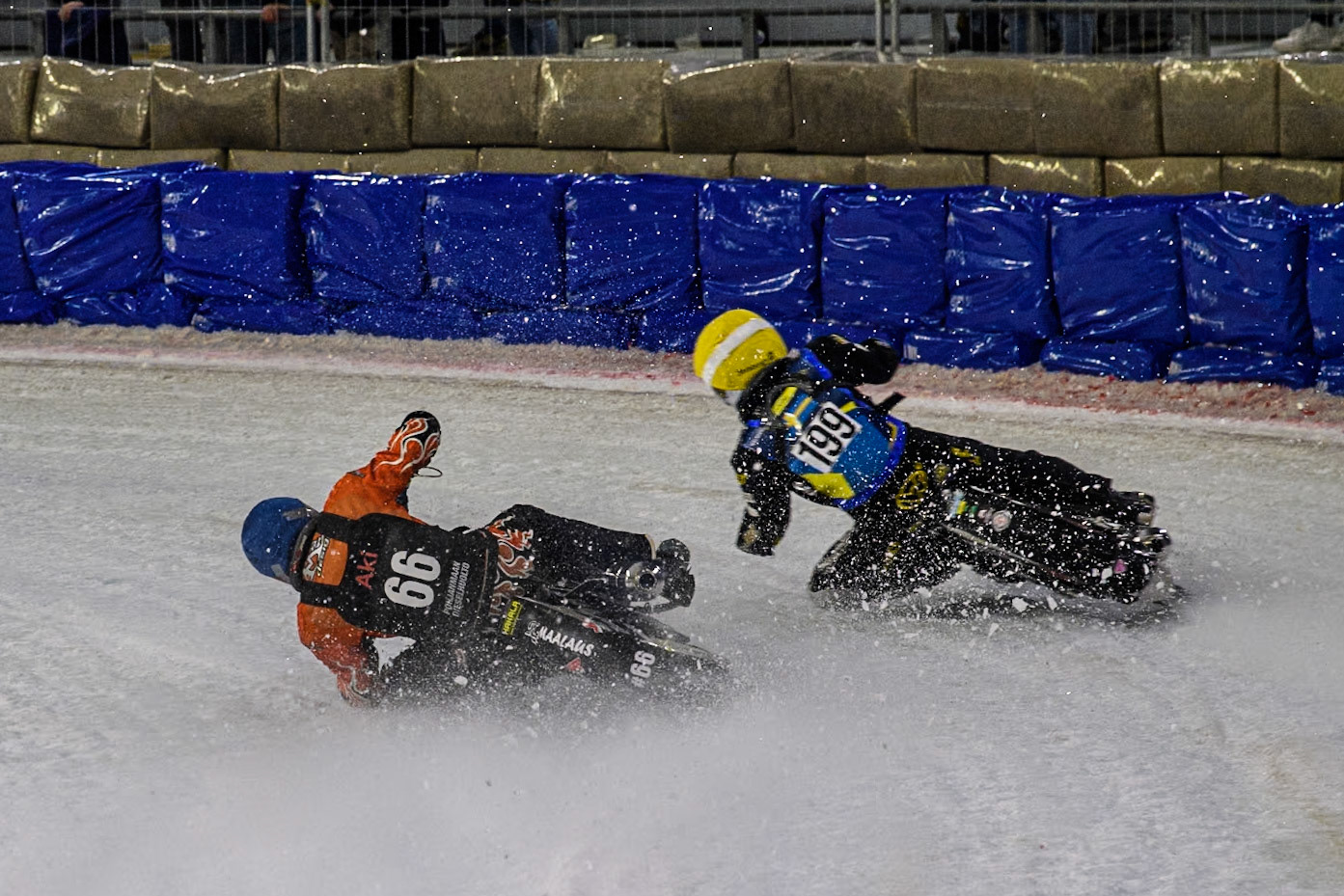 Finland's Aki Ala-Riihimäki (66) in Blue loses traction allowing 199\ in Yellow to pass him and take the lead during the FIM Ice Speedway Gladiators World Championship Final 3 at Ice Rink Thialf, Heerenveen on Saturday 6th April 2024. (Photo: Ian Charles | MI News)