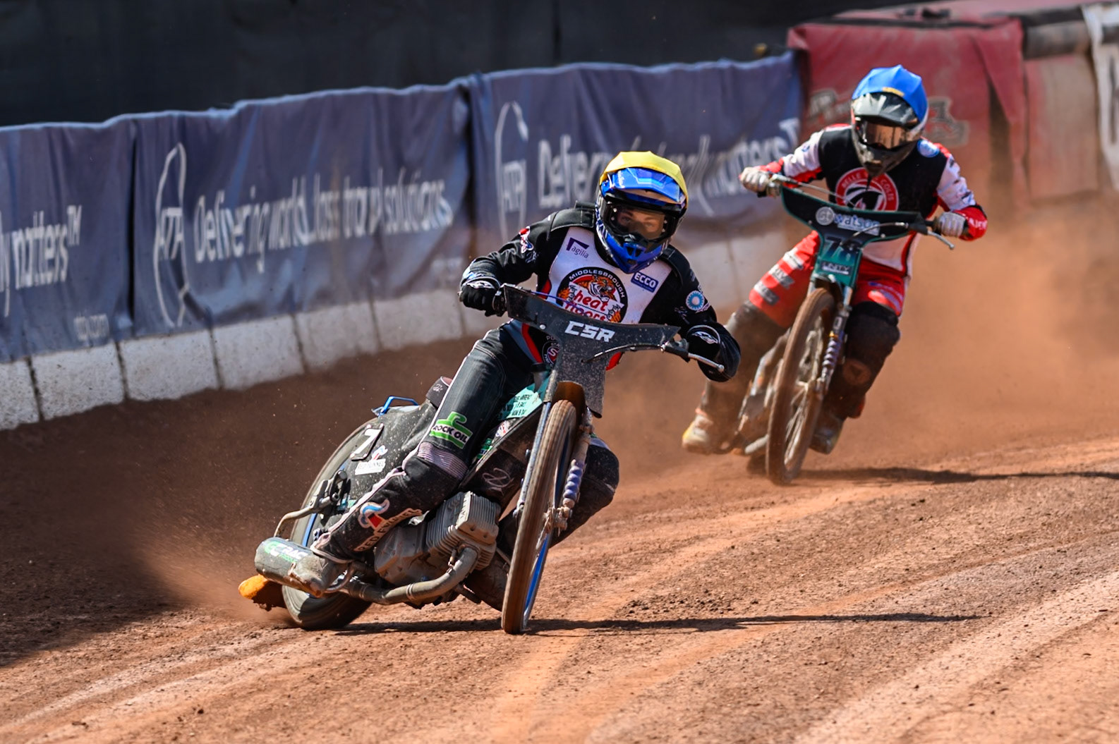 Charlie Southwick of Middlesborough Tigers  in Yellow leading Mason Watson of Belle Vue Colts  in Blue during the WSRA National Development League match between Belle Vue Colts and Middlesbrough Tigers at the National Speedway Stadium, Manchester on Sunday 10th August 2025. (Photo: Mark Fletcher | MI News)