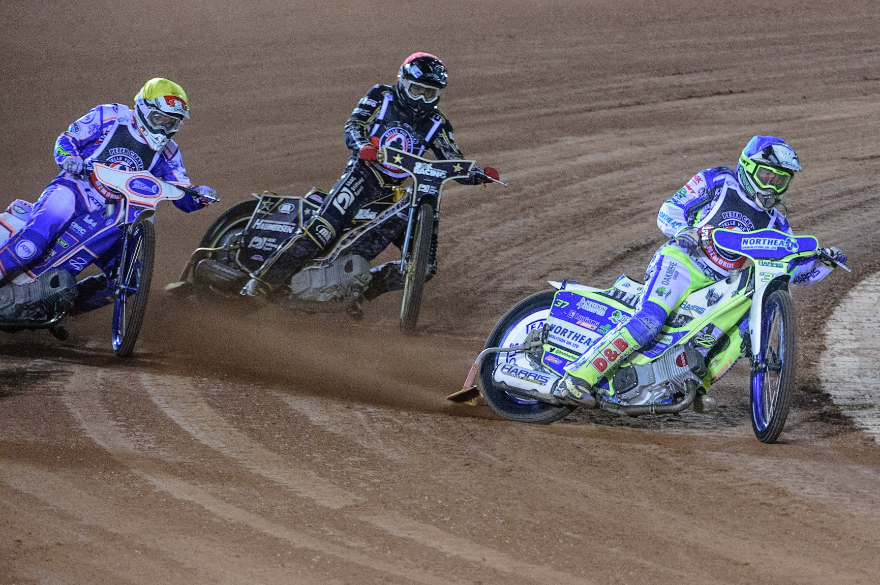 MANCHESTER, UK. OCT 23RD  Chris Harris  (Blue) leads Jason Crump  (Yellow) and Nick Blödorn  (Red) during the Peter Craven Memorial Trophy event at the National Speedway Stadium, Manchester on Saturday 23rd October 2021. (Credit: Ian Charles | MI News)