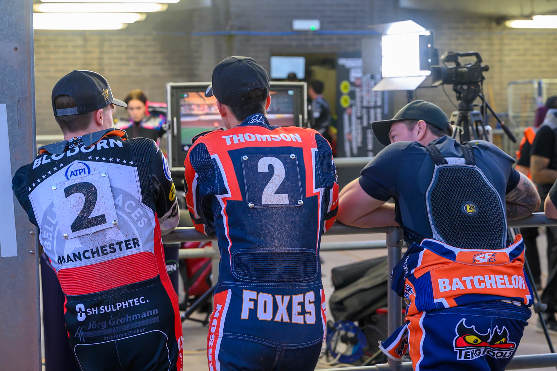 (L to R) Norick Blodorn of Belle Vue Aces ,Kye Thomson of Northampton Foxes  and Troy Batchelor of Northampton Foxes   wath the TV Monitor during the Rowe Motor Oil Premiership match between Belle Vue Aces and Northampton Foxes at the National Speedway Stadium, Manchester on Monday 13th July 2026. (Photo: Ian Charles | MI News)