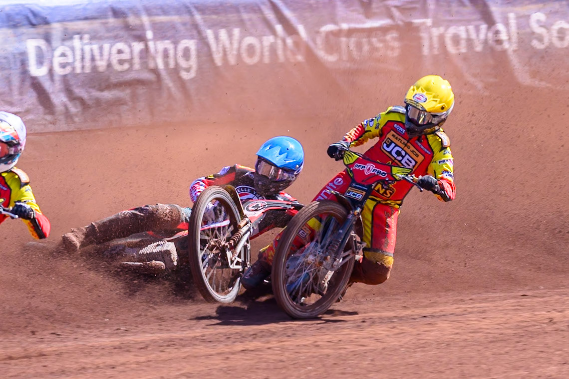 Kyle Howarth of Leicester Lions  in Yellow brings down Tate Zischke of Belle Vue Aces in Blue during the Knockout Cup Northern Section match between Belle Vue Aces and Leicester Lions at the National Speedway Stadium, Manchester on Monday 6th April 2026. (Photo: Ian Charles | MI News)