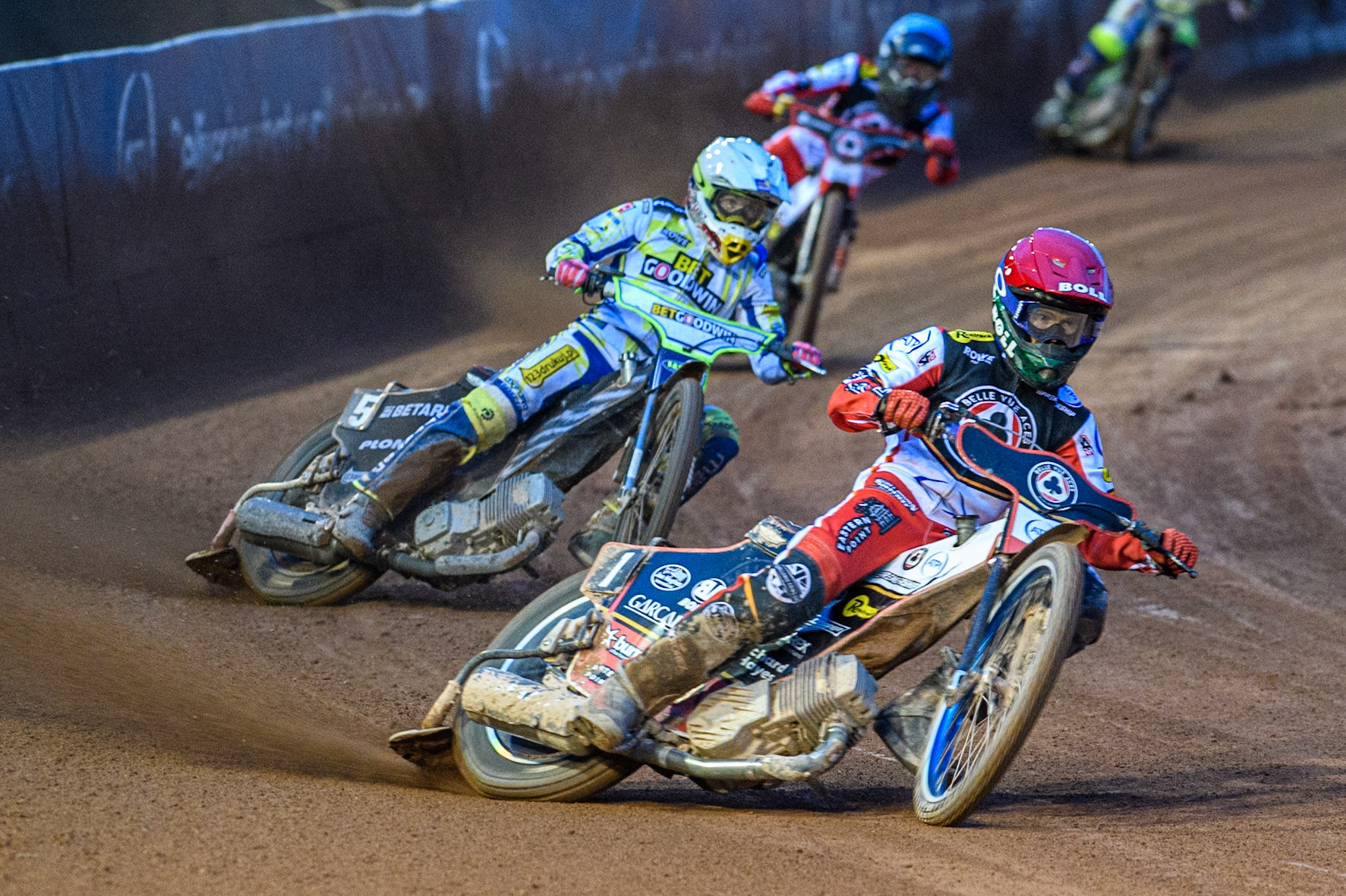 Belle Vue Aces' Brady Kurtz in Red leading Oxford Spires' Maciej Janowski in White and Belle Vue Aces' Norick Blodorn in Blue during the Rowe Motor Oil Premiership match between Belle Vue Aces and Oxford Spires at the National Speedway Stadium, Manchester on Monday 14th April 2025. (Photo: Ian Charles | MI News)