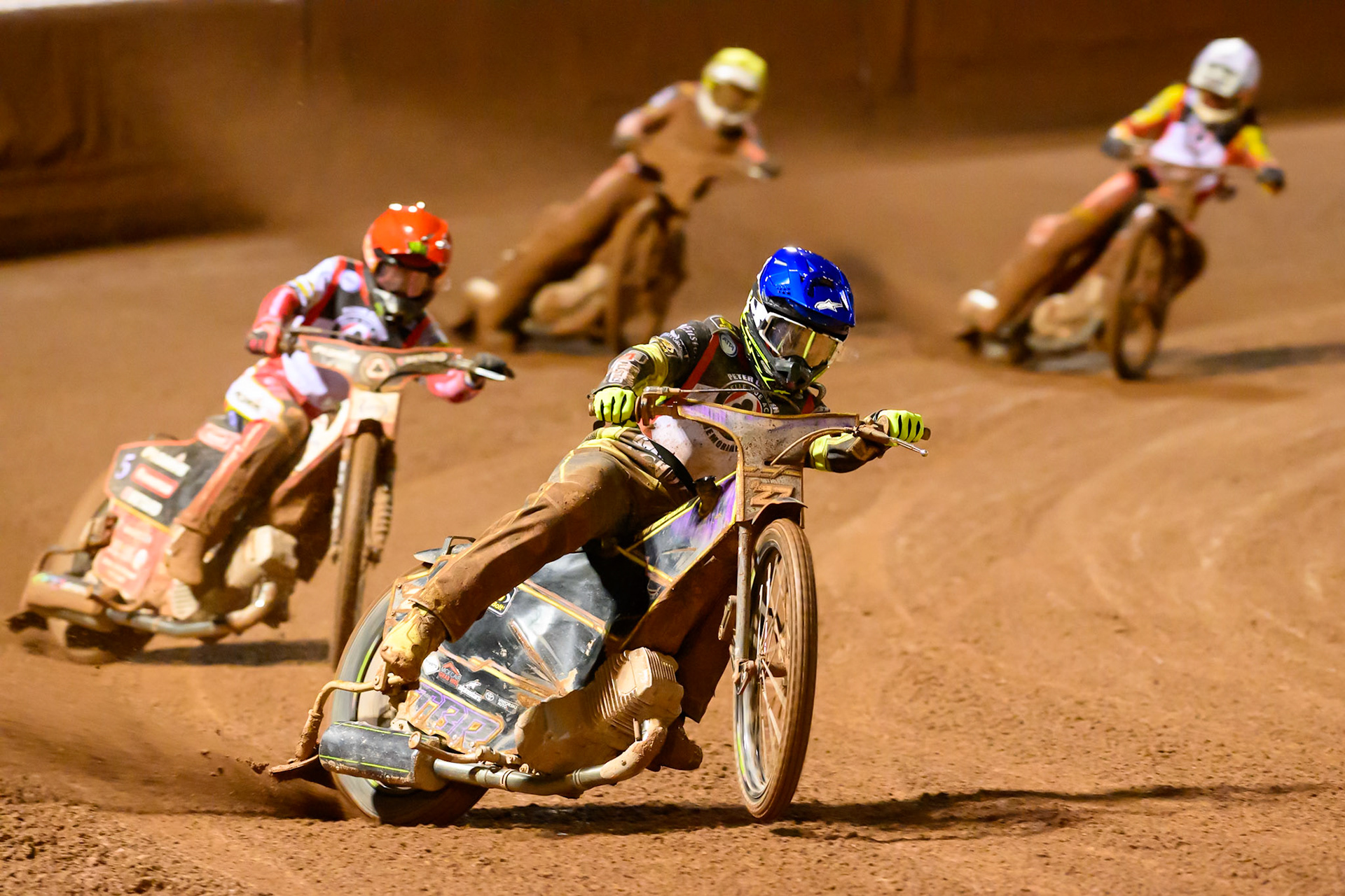 Tom Brennan  in Blue leading Dan Bewley in Red, Peter Kildemand  in Yellow and Sam Masters  in White during the Peter Craven Memorial Trophy at the National Speedway Stadium, Manchester, on Monday 16th March 2026. (Photo: Ian Charles | MI News)