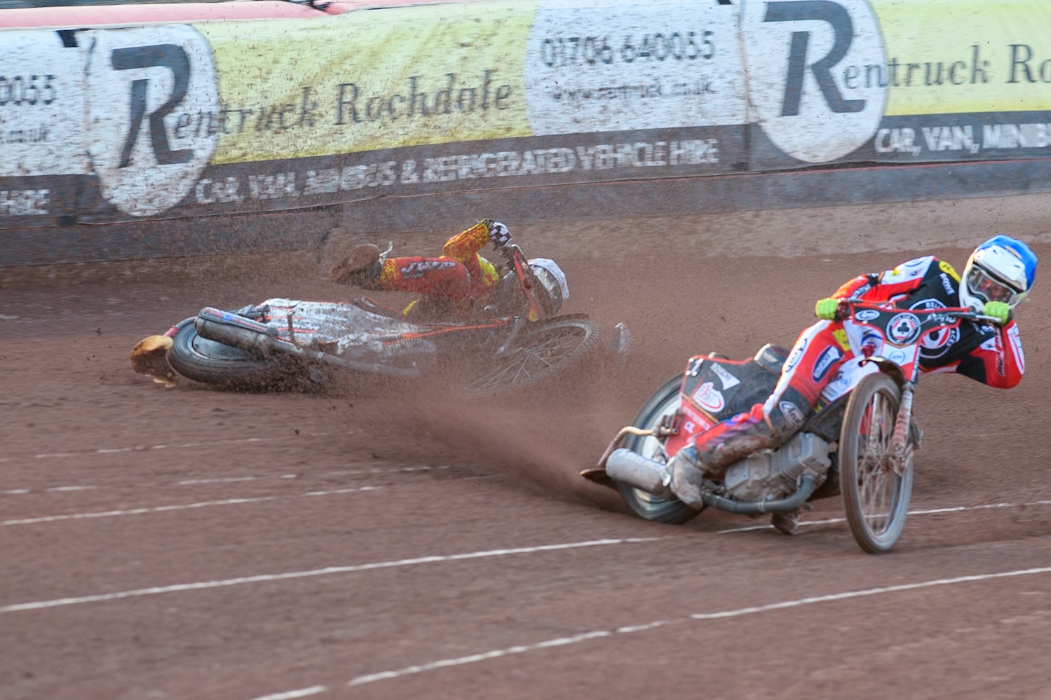 Leicester Lions' Sam Masters in White slides off outside of Belle Vue Aces' Jake Mulford in Blue during the Rowe Motor Oil Premiership match between Belle Vue Aces and Leicester Lions at the National Speedway Stadium, Manchester on Monday 19th May 2025. (Photo: Ian Charles | MI News)