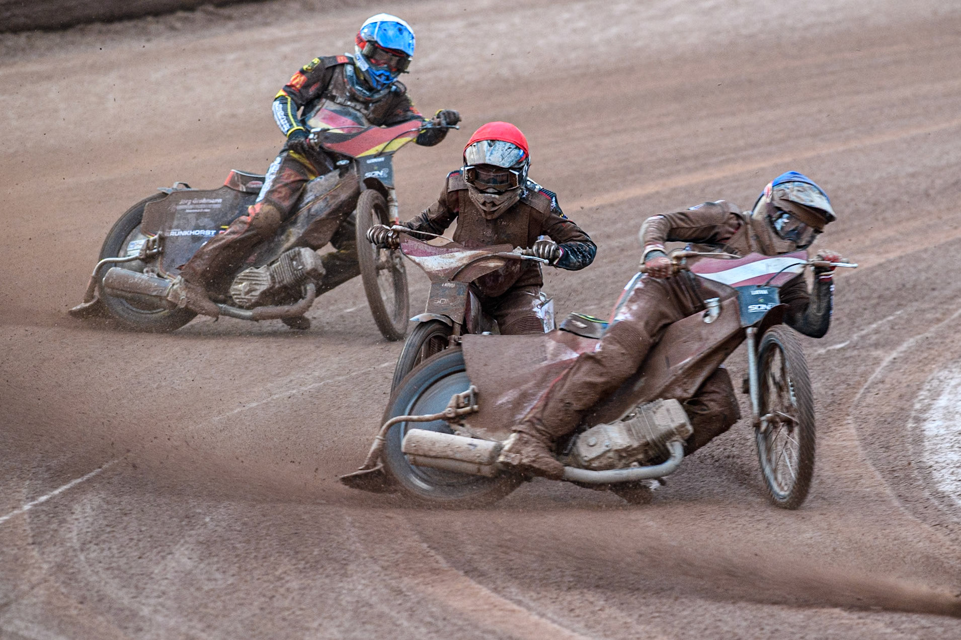 Norick Blödorn of Germany in Yellow leading Nikita Kaulins of Latvia in Blue as Artjoms Juhno of Latvia in Red picks up some drive ahead of Patrick Hyjek of Germany in White during the Monster Energy FIM Speedway of Nations 2 (Under 21) Final at the National Speedway Stadium, Manchester on Friday 12th July 2024. (Photo: Ian Charles | MI News)