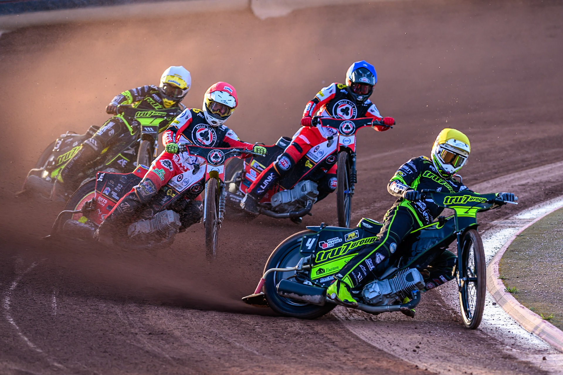 Tom Brennan of Ipswich Witches in Yellow leading Tate Zischke of Belle Vue Aces  in Red, Zach Cook of Belle Vue Aces  in Blue and Adam Ellis of Ipswich Witches in White during the Rowe Motor Oil Premiership match between Belle Vue Aces and Ipswich Witches at the National Speedway Stadium, Manchester on Monday 4th August 2025. (Photo: Ian Charles | MI News)