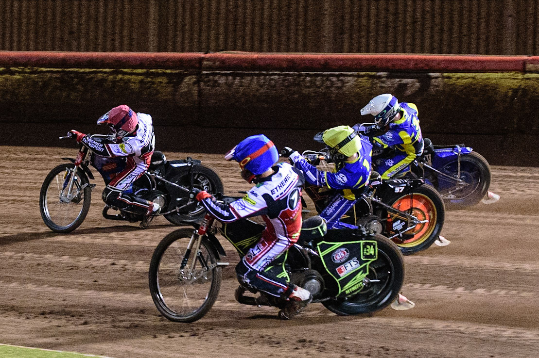 MANCHESTER, UK. OCT 7TH  Jye Etheridge   (Blue) tries to pass Danyon Hume  (Yellow) and Kyle Howarth  (White) as they chase Steve Worrall   (Red) during the SGB Premiership Play off Semi-Final Second Leg between Belle Vue Aces and Sheffield Tigers at the National Speedway Stadium, Manchester on Thursday 7th October 2021. (Credit: Ian Charles | MI News)