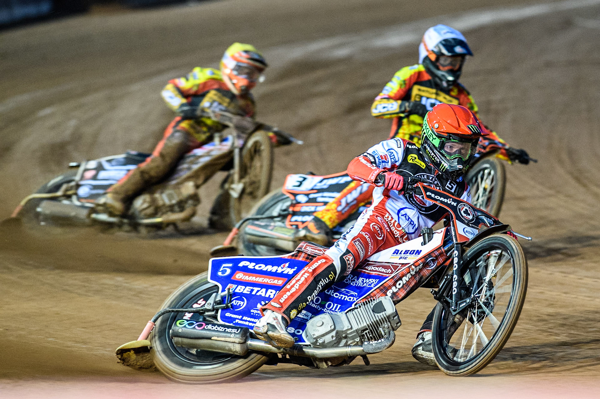 Dan Bewley of Belle Vue Aces in Red leading Sam Masters of Leicester Lions in White and Luke Becker of Leicester Lions in Yellow during the Rowe Motor Oil Premiership match between Belle Vue Aces and Leicester Lions at the National Speedway Stadium, Manchester on Saturday 6th April 2024. (Photo: Ian Charles | MI News)