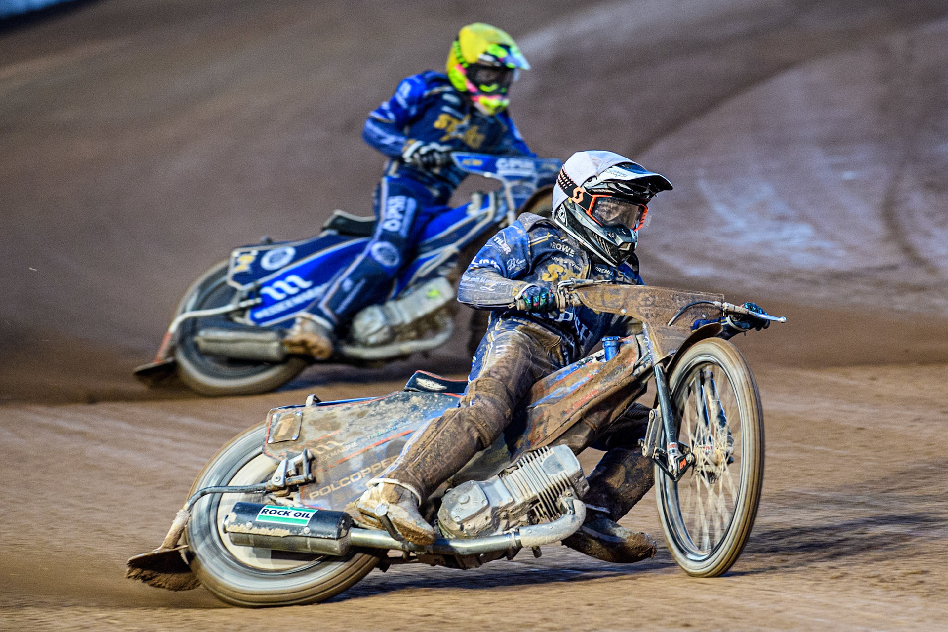 Ben Cook of Kings Lynn Stars in White leading team mate Richard Lawson in Yellow during the Rowe Motor Oil Premiership match between Belle Vue Aces and King's Lynn Stars at the National Speedway Stadium, Manchester on Monday 5th April 2025. (Photo: Ian Charles | MI News)