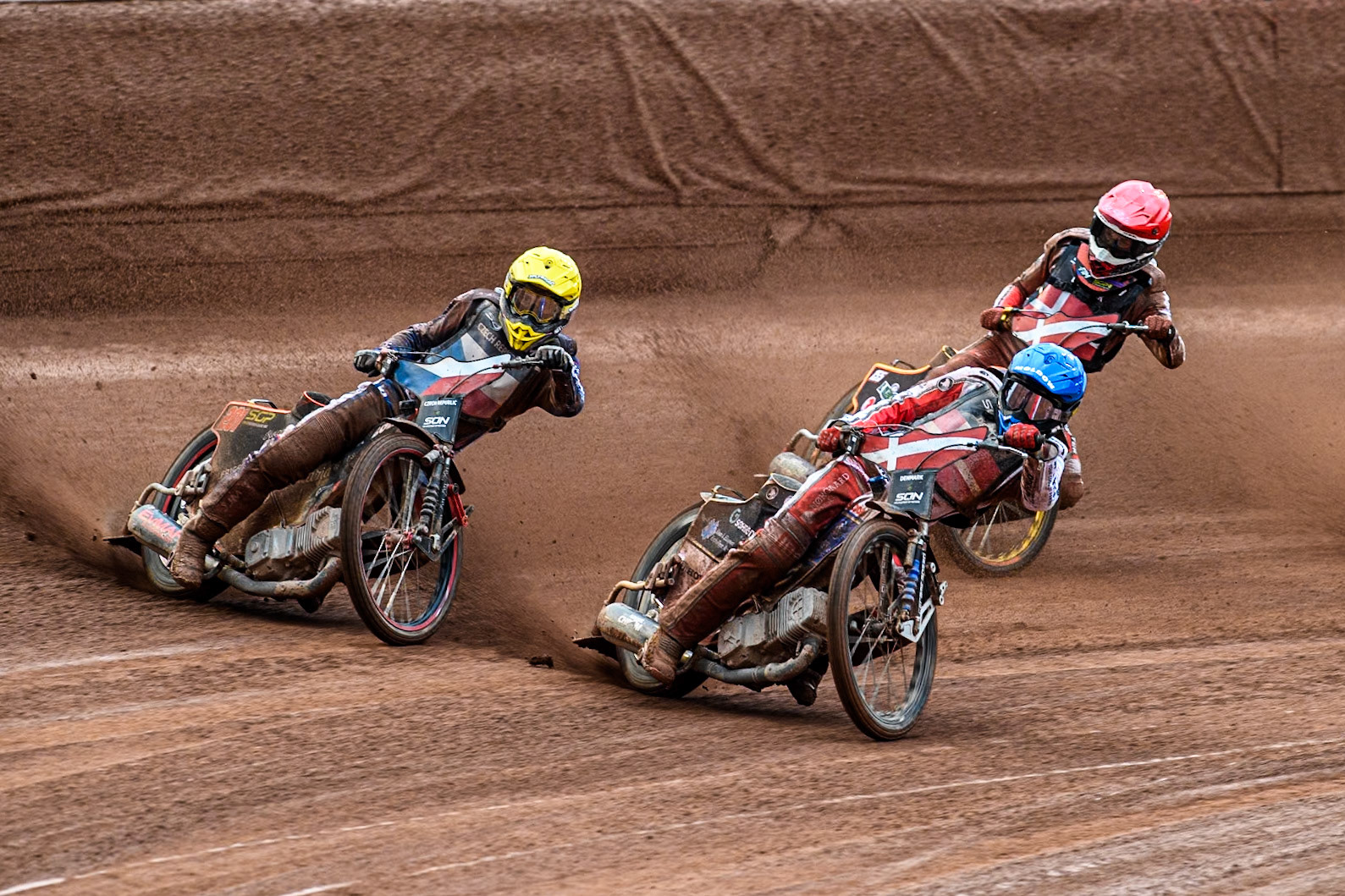 Rasmus Jensen of Denmark in Blue rides inside Jan Kvech of The Czech Republic in Yellow with Mikkel Michelsen of Denmark in Red behind during the Monster Energy FIM Speedway of Nation Semi Final 2 at the National Speedway Stadium, Manchester on Wednesday 10th July 2024. (Photo: Ian Charles | MI News)