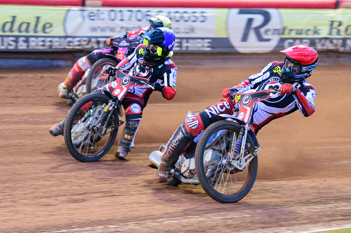 Matej Zagar (Red) and Tom Brennan (Blue) team ride past Scott Nicholls  (Yellow) during the SGB Premiership match between Belle Vue Aces and Peterborough at the National Speedway Stadium, Manchester on Monday 25th July 2022. (Credit: Ian Charles | MI News