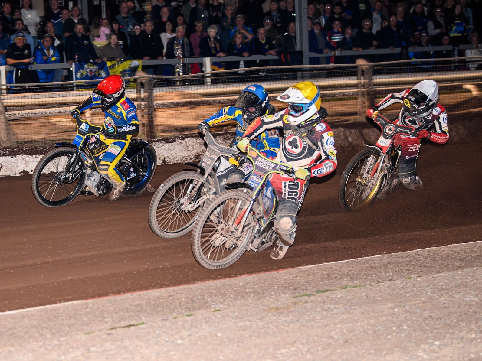 Belle Vue Aces' Jake Mulford  in Yellow rides inside Sheffield Tigers' Guest Rider Joe Thompson  in Blue and Sheffield Tigers' Kyle Howarth  in Red with Belle Vue Aces' Norick Blödorn  in White behind during the Rowe Motor Oil Premiership match between Sheffield Tigers and Belle Vue Aces at Owlerton Stadium, Sheffield on Monday 26th August 2024. (Photo: Ian Charles | MI News)