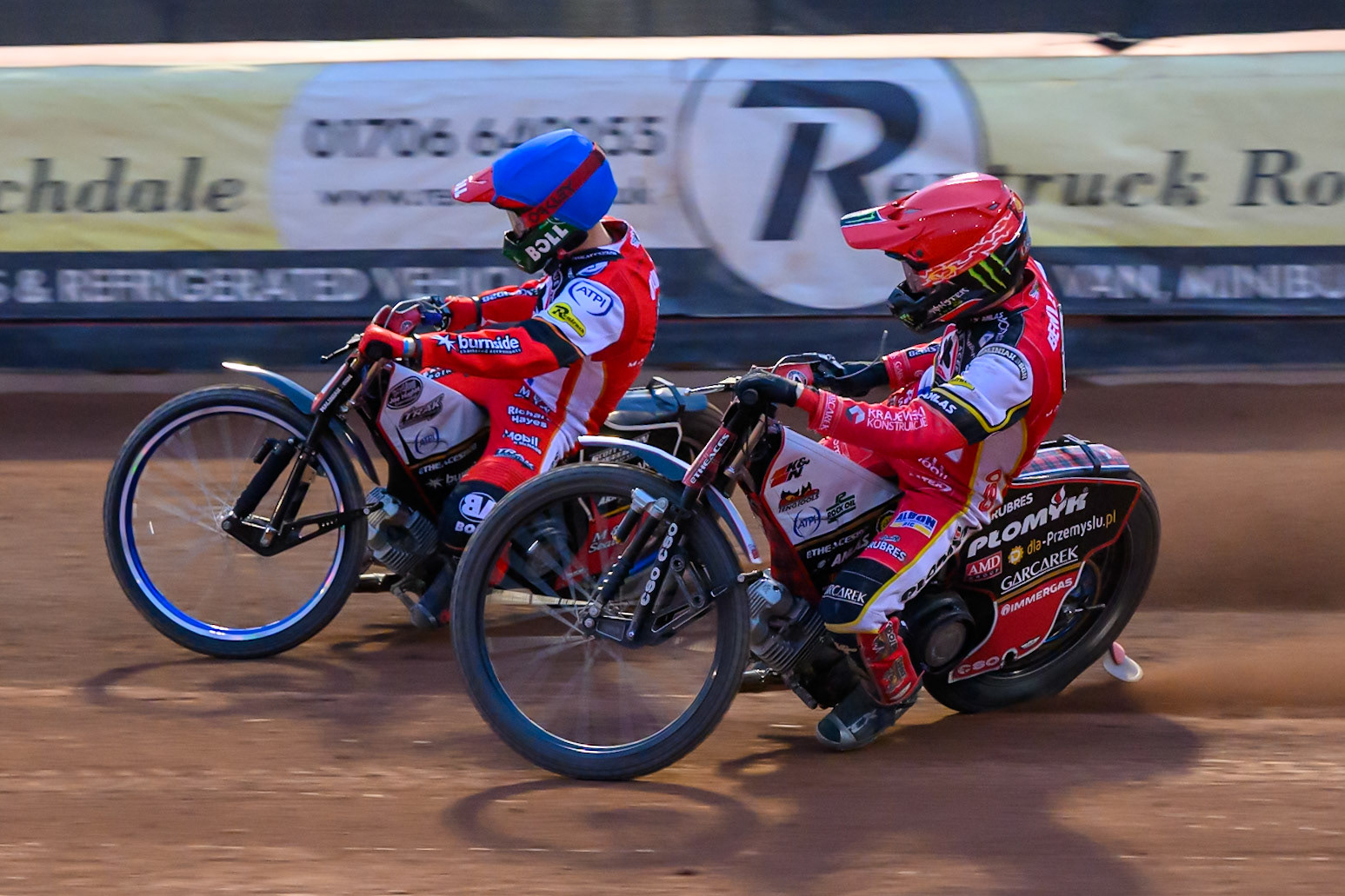Belle Vue Aces' Dan Bewley in Red on the inside of team mate Brady Kurtz during the Rowe Motor Oil Premiership match between Belle Vue Aces and King's Lynn Stars at the National Speedway Stadium, Manchester on Monday 23rd June 2025. (Photo: Ian Charles | MI News)