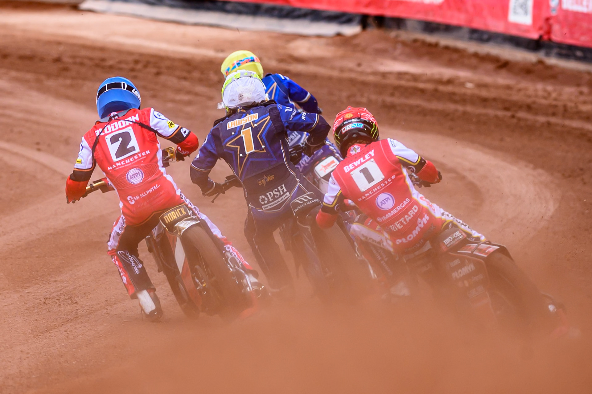 Belle Vue Aces' Dan Bewley in Red chases Belle Vue Aces' Norick Blödorn in Blue, Kings Lynn Stars' Richard Lawson in White and Kings Lynn Stars' Niels-Kristian Iversen in Yellow during the Rowe Motor Oil Premiership match between Belle Vue Aces and King's Lynn Stars at the National Speedway Stadium, Manchester on Monday 23rd June 2025. (Photo: Ian Charles | MI News)