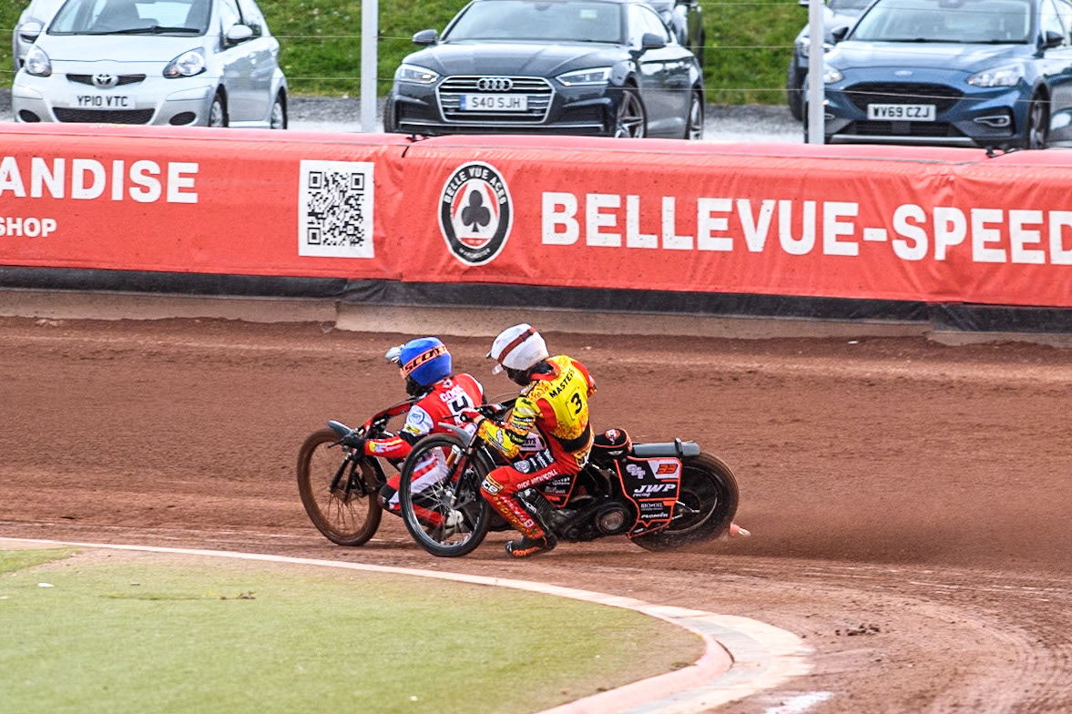 Belle Vue Aces' Ben Cook in Blue passes Leicester Lions' Sam Masters in White during the Rowe Motor Oil Premiership match between Belle Vue Aces and Leicester Lions at the National Speedway Stadium, Manchester on Monday 24th June 2024. (Photo: Ian Charles | MI News)