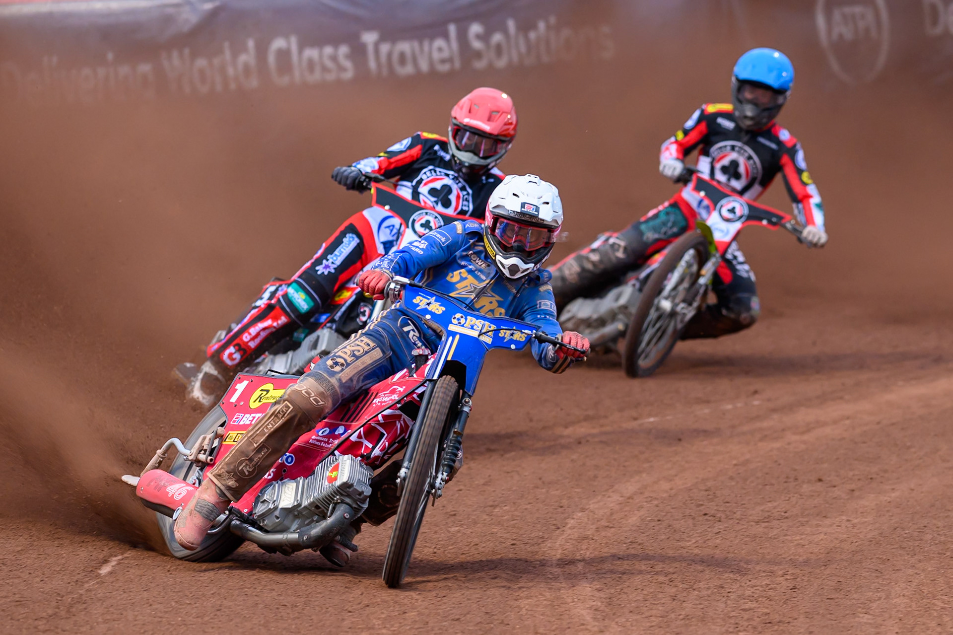 Max Fricke of Kings Lynn Stars in White leading Jason Doyle of Belle Vue Aces in Red and Tate Zischke of Belle Vue Aces in Blue during the Rowe Motor Oil Premiership match between Belle Vue Aces and King's Lynn Stars at the National Speedway Stadium, Manchester on Monday 29th June 2026. (Photo: Ian Charles | MI News)