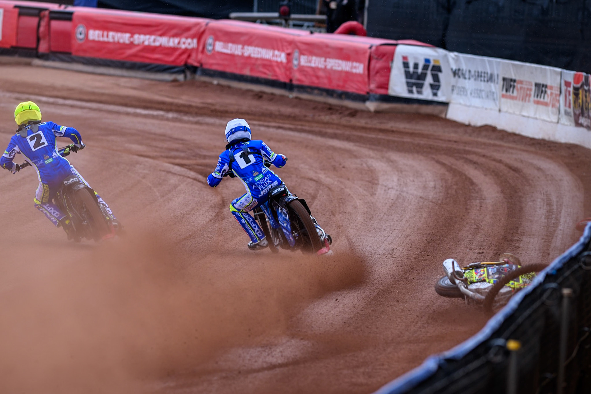 Belle Vue Colts' William Cairns falls whilst trying to pass Oxford Chargers' Jody Scott  in White and Oxford Chargers' Jacob Clouting  in Yellow during the WSRA National Development League match between Belle Vue Colts and Oxford Chargers at the National Speedway Stadium, Manchester on Sunday 1st June 2025. (Photo: Ian Charles | MI News)