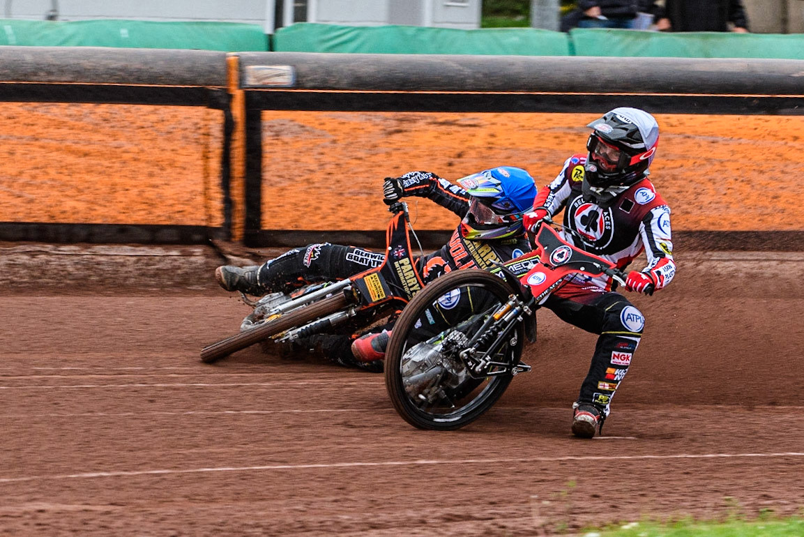 Tom Brennan (White) inside Leon Flint (Blue) as he falls in the first bend during the Sports Insure Premiership match between Wolverhampton Wolves and Belle Vue Aces at Monmore Green Stadium, Wolverhampton on Monday 10th July 2023. (Photo: Ian Charles | MI News)