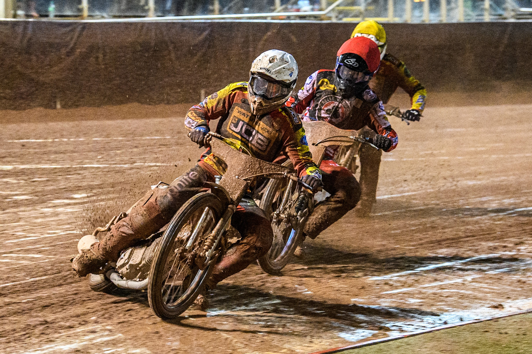 Leicester Lions' Ryan Douglas  in White leading Belle Vue Aces' Brady Kurtz  in Red and Leicester Lions' Richard Lawson  in Yellow during the Rowe Motor Oil Premiership Grand Final 1st Leg between Belle Vue Aces and Leicester Lions at the National Speedway Stadium, Manchester on Monday 23rd September 2024. (Photo: Ian Charles | MI News)
