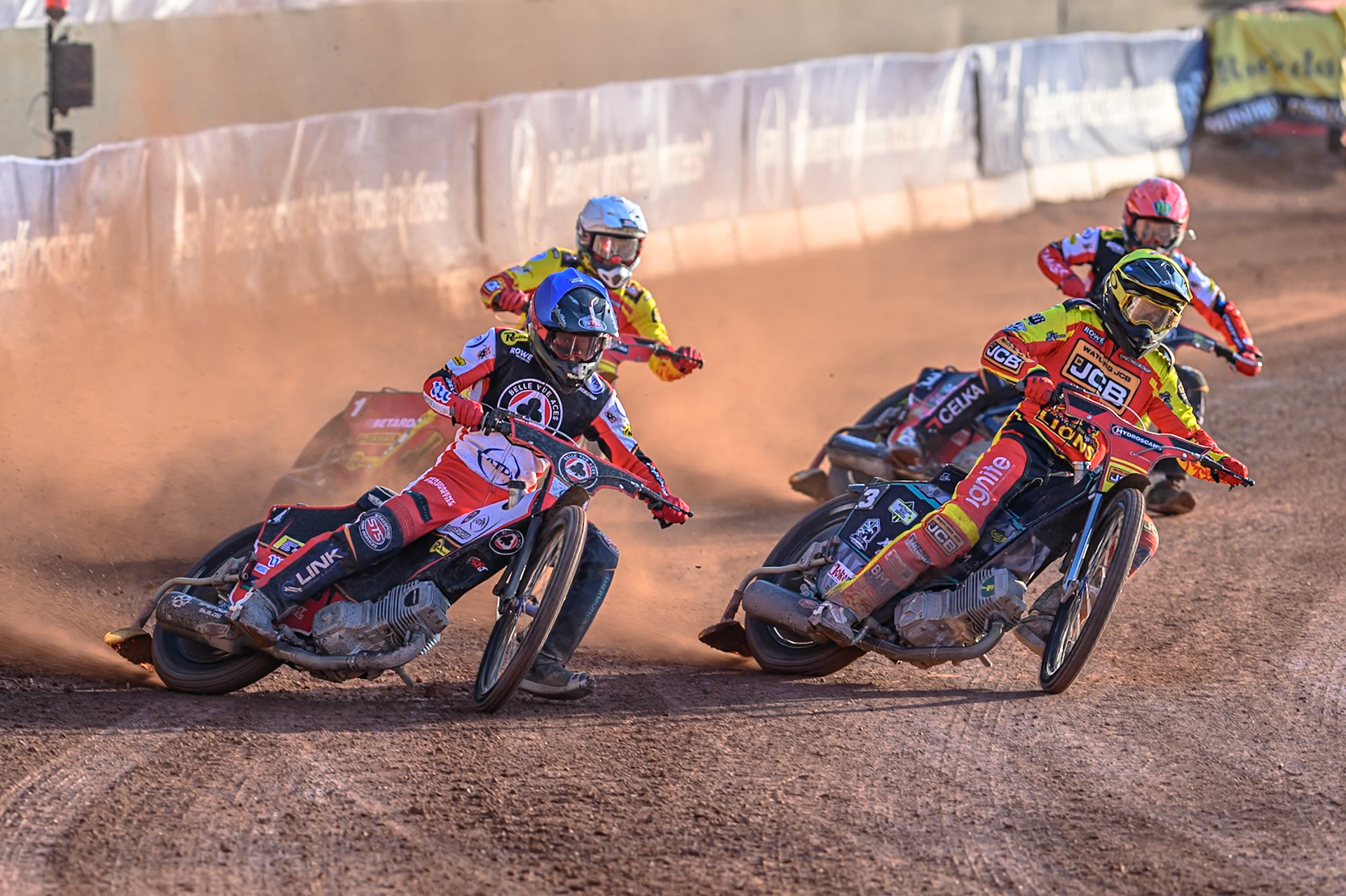Belle Vue Aces' Zach Cook in Blue rides outside Leicester Lions' Ryan Douglas  in Yellow with Leicester Lions' Max Fricke  in White and Belle Vue Aces' Jaimon Lidsey in Red behind during the Rowe Motor Oil Premiership match between Belle Vue Aces and Leicester Lions at the National Speedway Stadium, Manchester on Monday 14th July 2025. (Photo: Ian Charles | MI News)