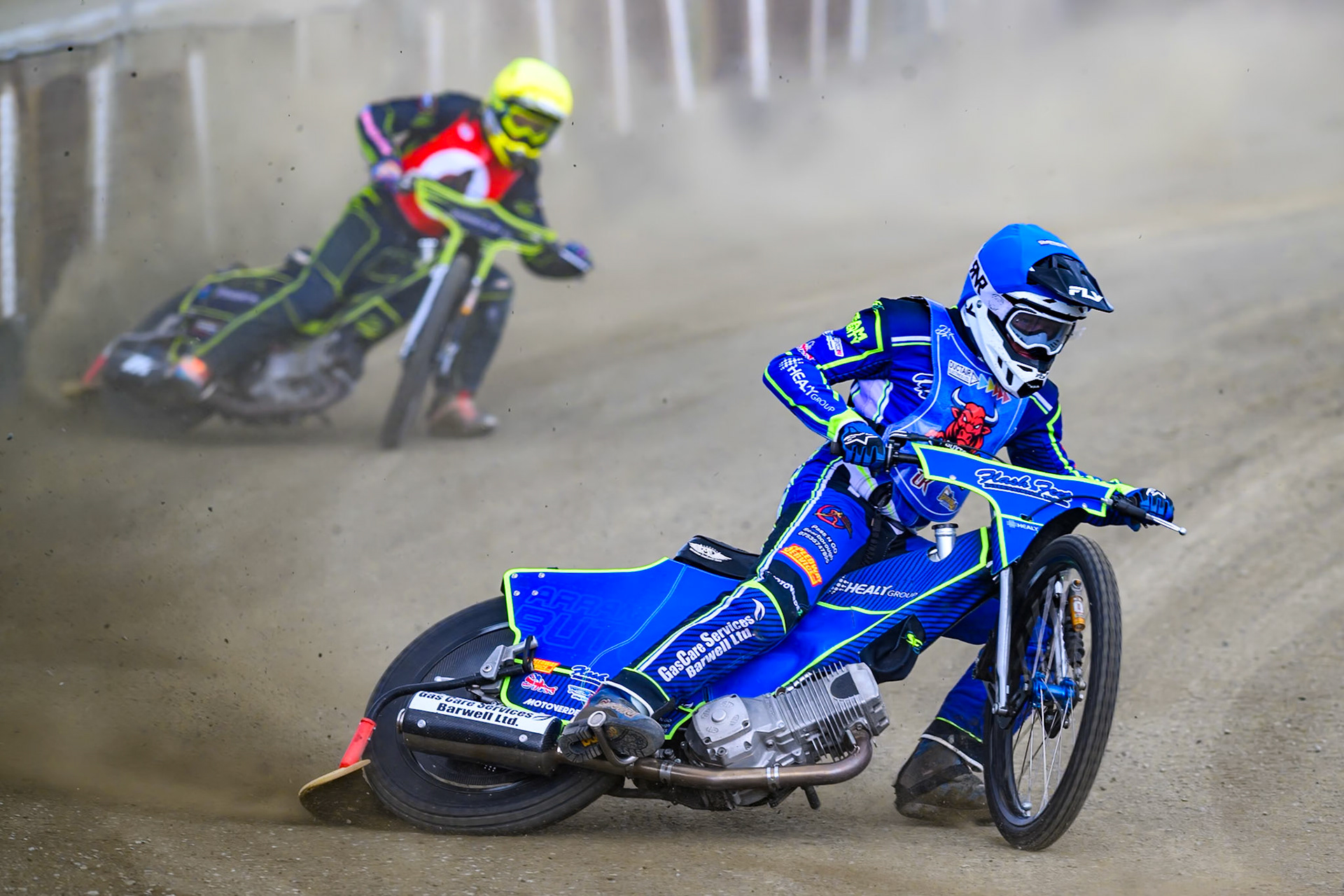 Arran Butcher of Buxton Bulls  in Blue leading Ben Whalley of NDL Nomads    in Yellow during the  Challenge match between Buxton Bulls and NDL Nomads at Hi-Edge Speedway, Buxton on Sunday 19th April 2026. (Photo: Ian Charles | MI News)