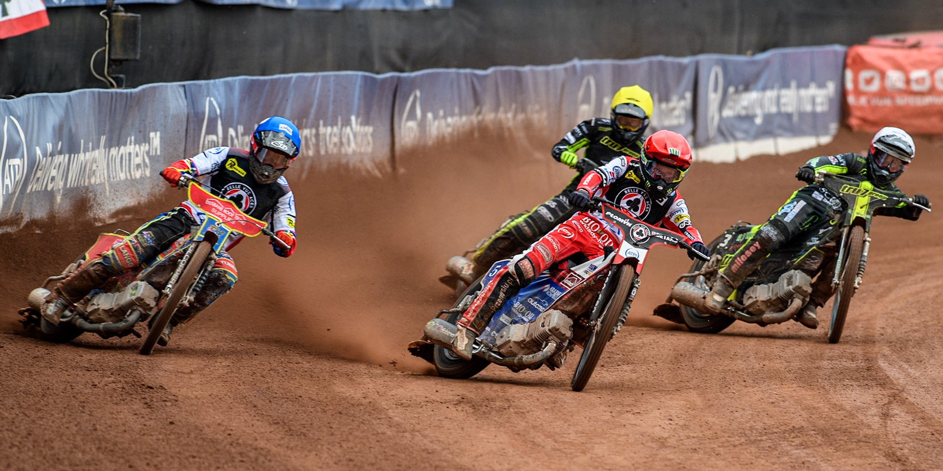Belle Vue Aces' Dan Bewley  in Red and Belle Vue Aces' Tate Zischke  in Blue leading Ipswich Witches' Adam Ellis in Yellow and Ipswich Witches' Danny King in White during the Rowe Motor Oil Premiership match between Belle Vue Aces and Ipswich Witches at the National Speedway Stadium, Manchester on Monday 1st July 2024. (Photo: Ian Charles | MI News)