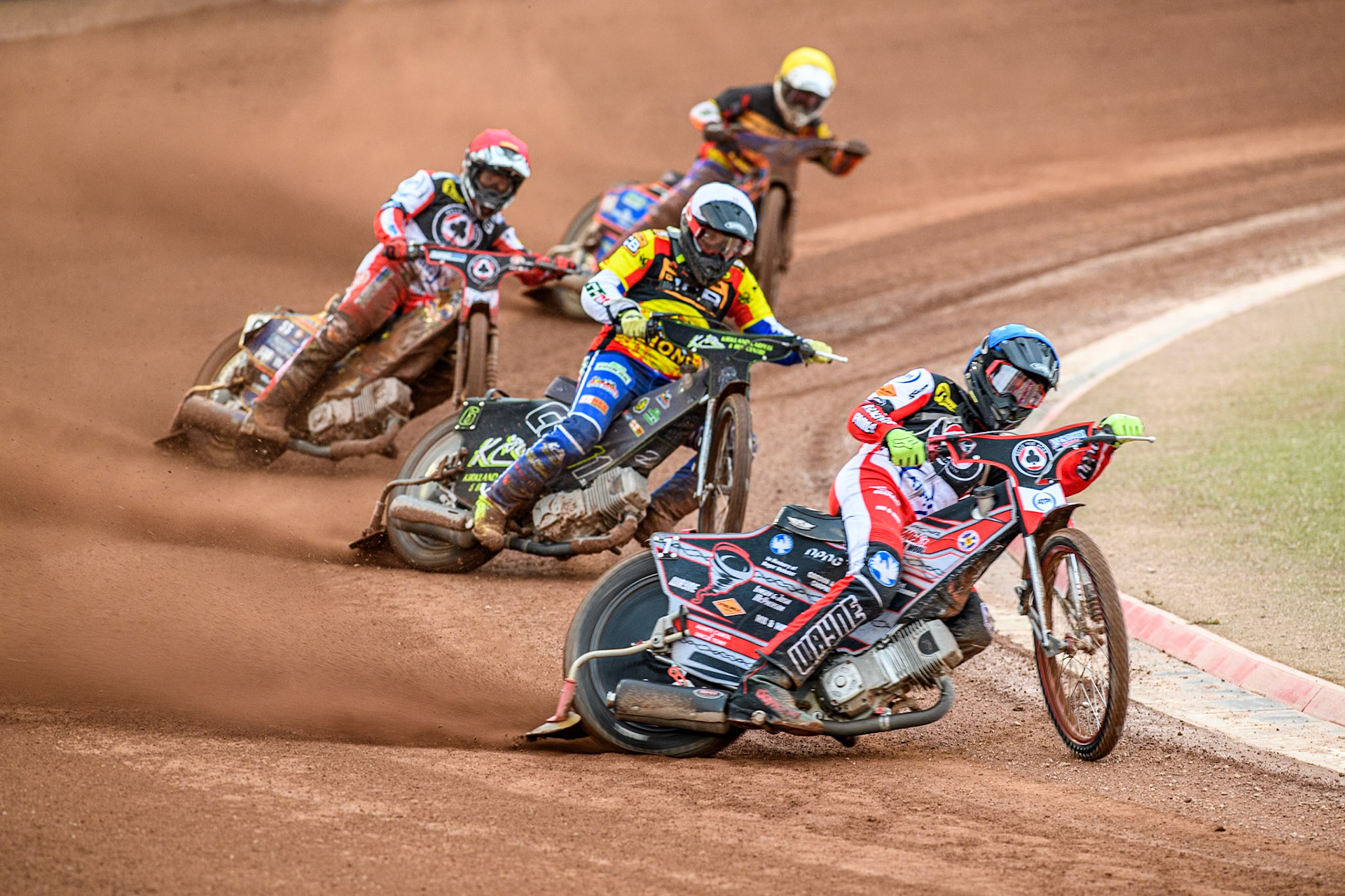 Belle Vue Aces' Connor Bailey in Blue leading Leicester Lions' Craig Cook in White, Belle Vue Aces' Connor Mountain in Red and Leicester Lions' Guest rider Luke Killeen in Yellow during the Rowe Motor Oil Premiership match between Belle Vue Aces and Leicester Lions at the National Speedway Stadium, Manchester on Monday 24th June 2024. (Photo: Ian Charles | MI News)