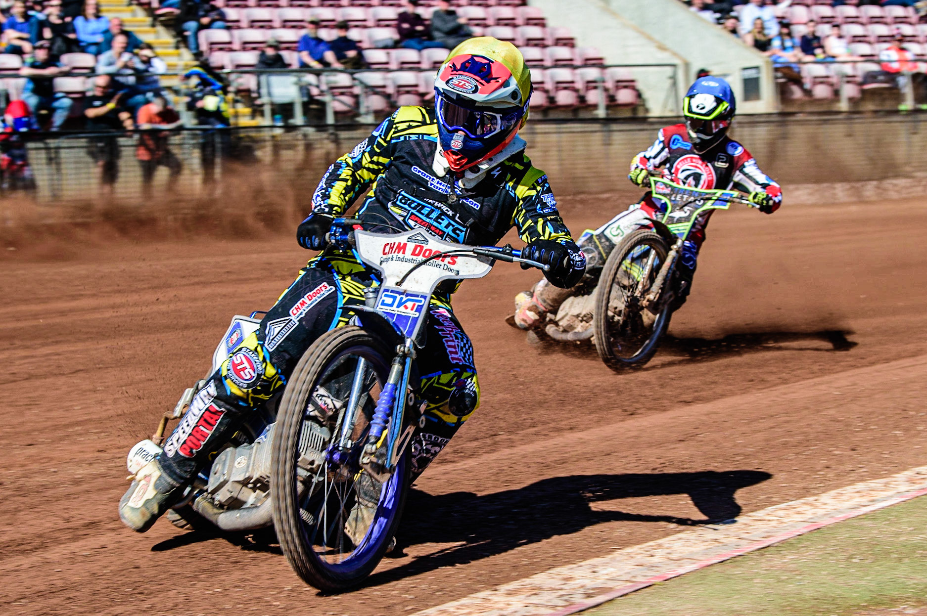 Danny Phillips  (Yellow) leads Luke Muff  (Blue) during the National Development League match between Belle Vue Colts and Berwick Bullets at the National Speedway Stadium, Manchester on Friday 7th April 2023. (Photo: Ian Charles | MI News)