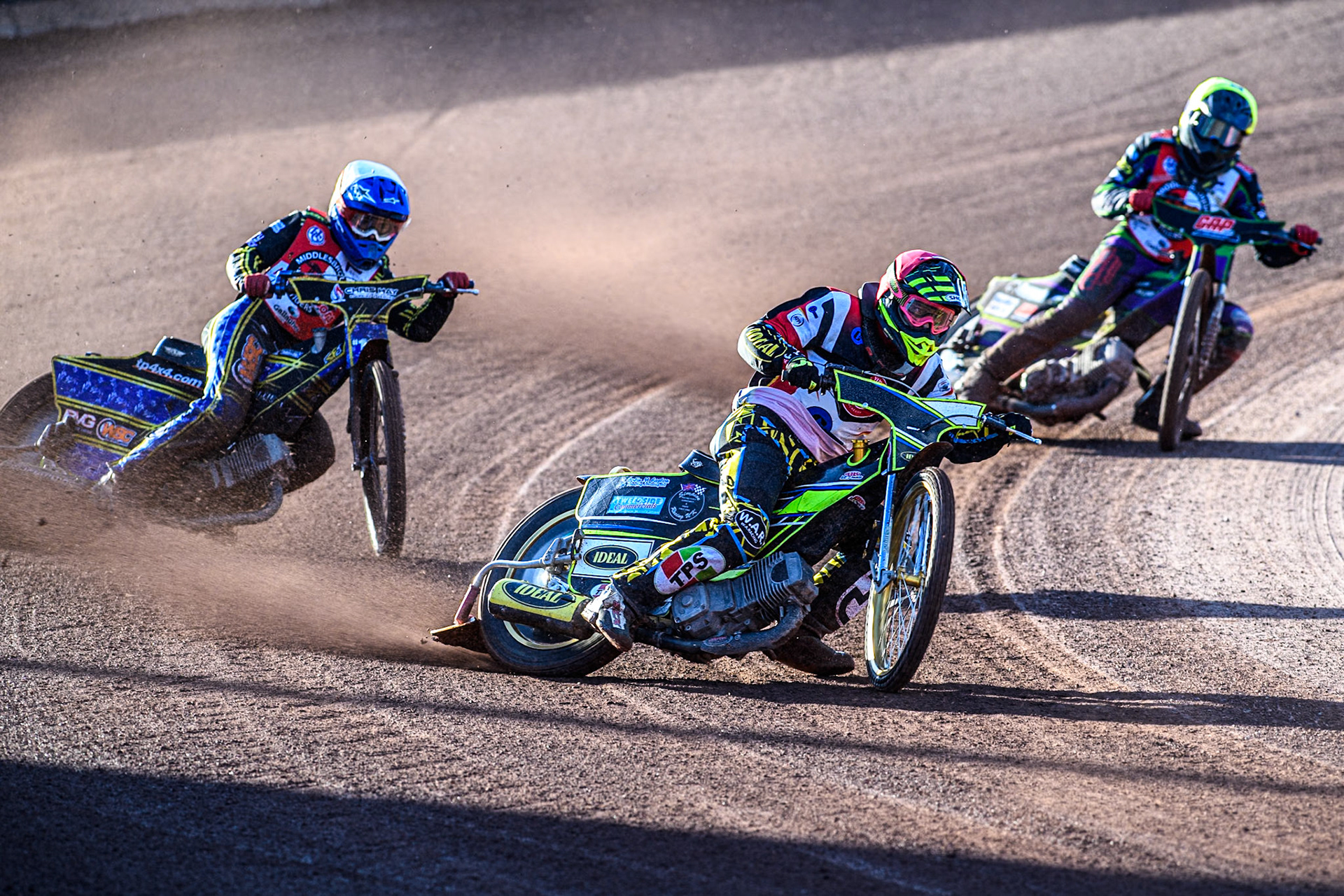 Belle Vue Colts' Guest rider Keiran Douglas in Red leading Middlesbrough Tigers' William Hocaniuk in White and Middlesbrough Tigers' Kai Ward in Yellow during the WSRA National Development League match between Belle Vue Colts and Middlesbrough Tigers at the National Speedway Stadium, Manchester on Monday 17th June 2024. (Photo: Ian Charles | MI News)