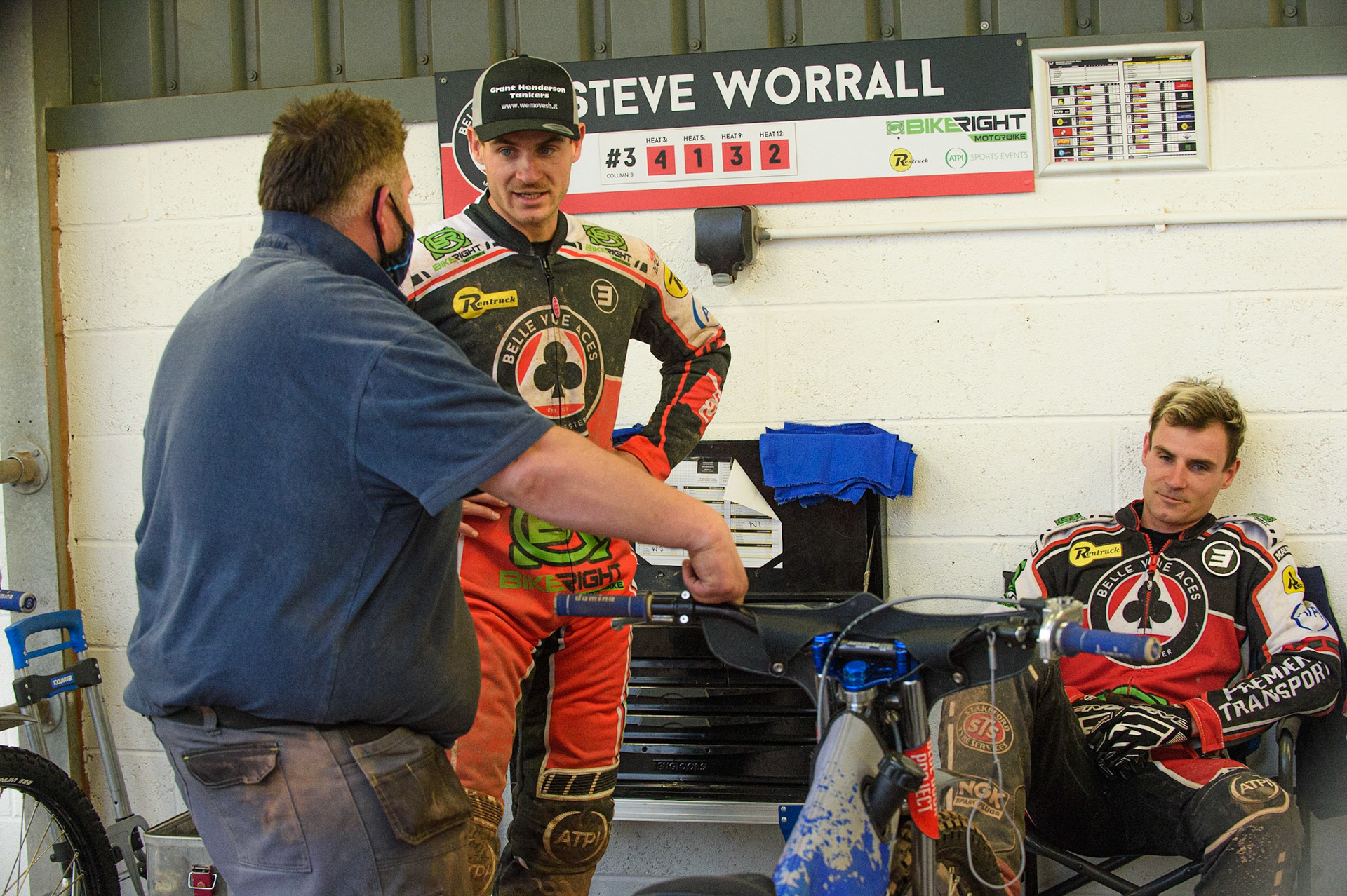 MANCHESTER, UK. JUNE 7TH   Richie Worrall (centre) and Charles Wright  (seated) discuss their machine set ups with their mechanic during the SGB Premiership match between Belle Vue Aces and Ipswich Witches at the National Speedway Stadium, Manchester on Monday 7th June 2021. (Credit: Ian Charles | MI News)