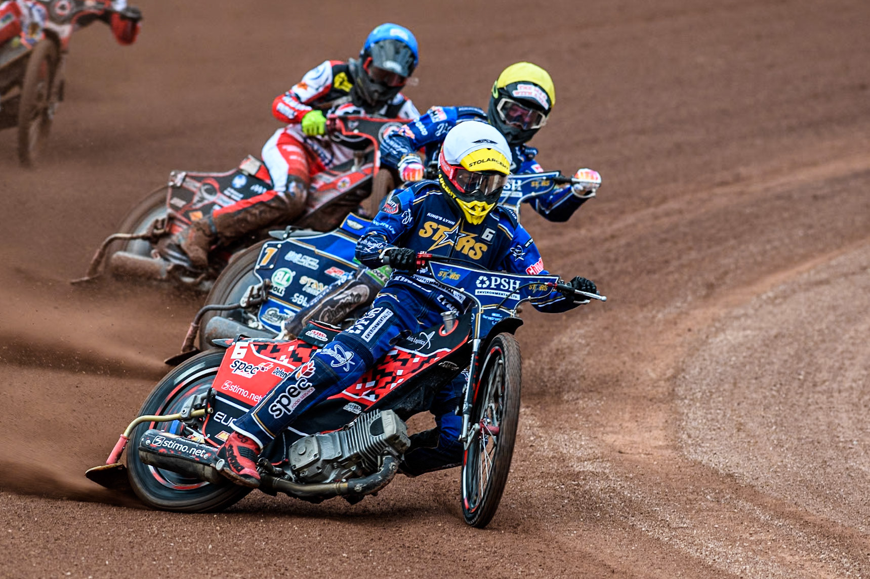King Lynn Stars' Patryk Wojdylo in White and King Lynn Stars' Anders Rowe in Yellow leading Belle Vue Aces' Connor Bailey in Blue during the Rowe Motor Oil Premiership match between Belle Vue Aces and King's Lynn Stars at the National Speedway Stadium, Manchester on Monday 20th May 2024. (Photo: Ian Charles | MI News)